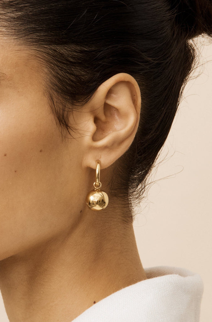 Model's side profile view in the Sphere Hoops Earrings bagatiba