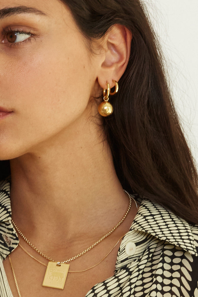 Cropped view on model of the Sphere Hoops Earrings bagatiba