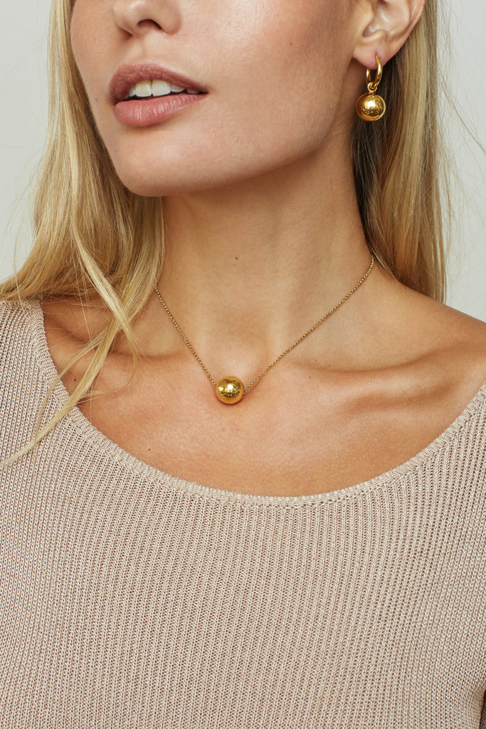Cropped view on model of the Sphere Hoops Earrings bagatiba