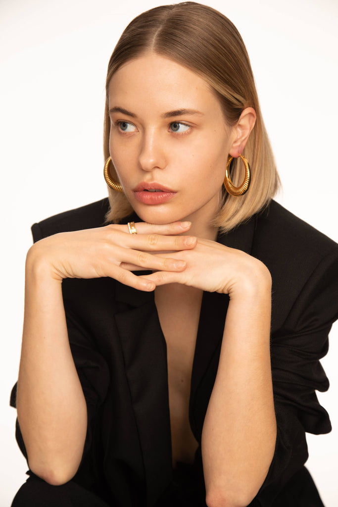 Model wearing the Spiral Hoops Earrings bagatiba