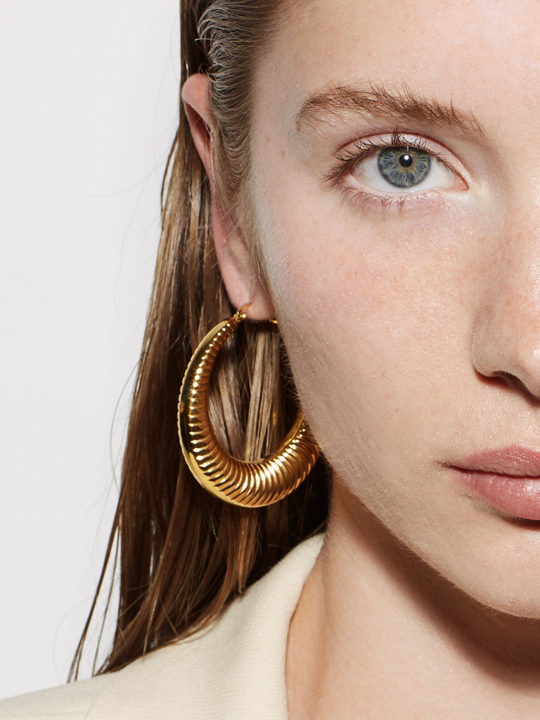 Detail cropped view on model of the Spiral Hoops Earrings bagatiba