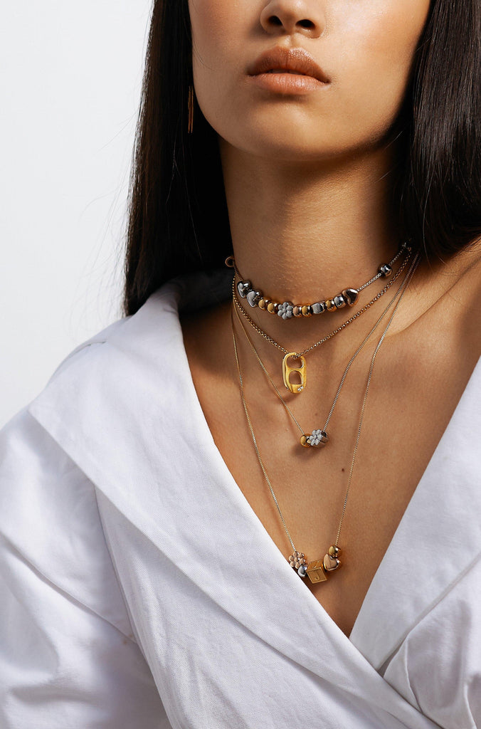 Model wearing 4 custom build it necklaces  Bagatiba
