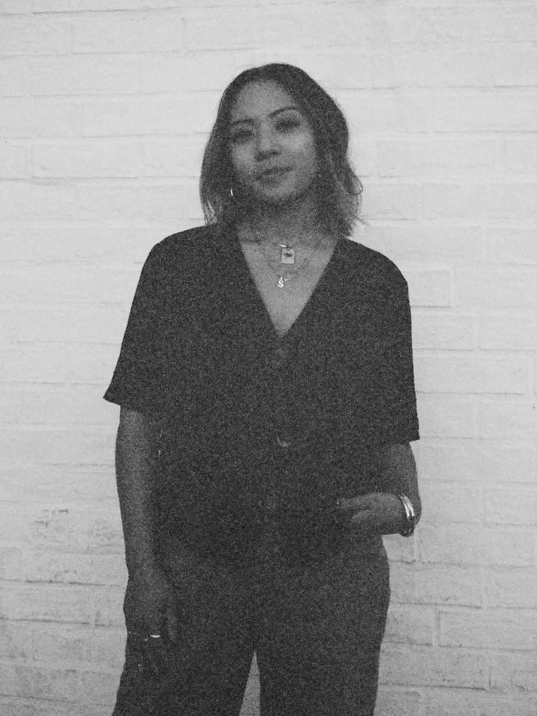 Black and white portrait of woman wearing the Taurus Charm charm Bagatiba