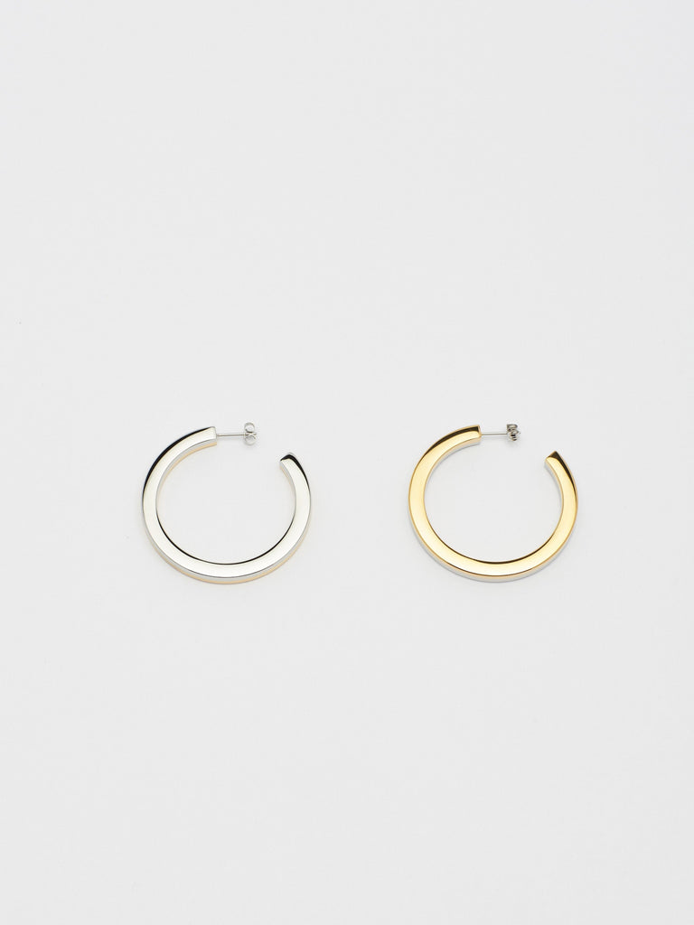 Flat lay overhead view of Two Tone Flat Hollow Hoops Earrings Bagatiba