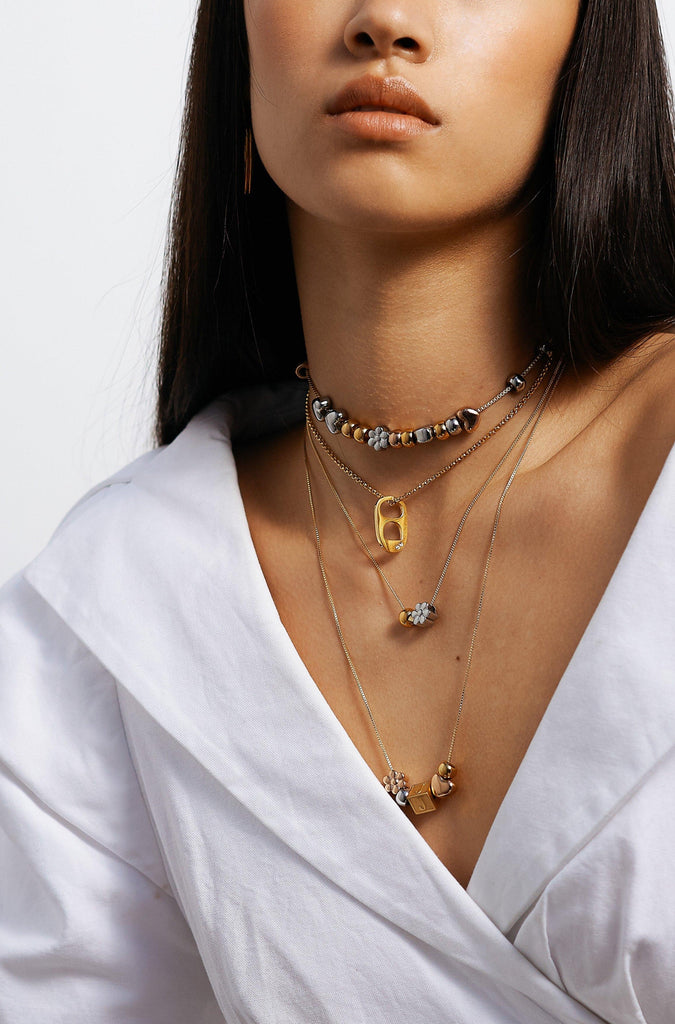 Full view of model wearing 4 custom build it necklaces  Bagatiba
