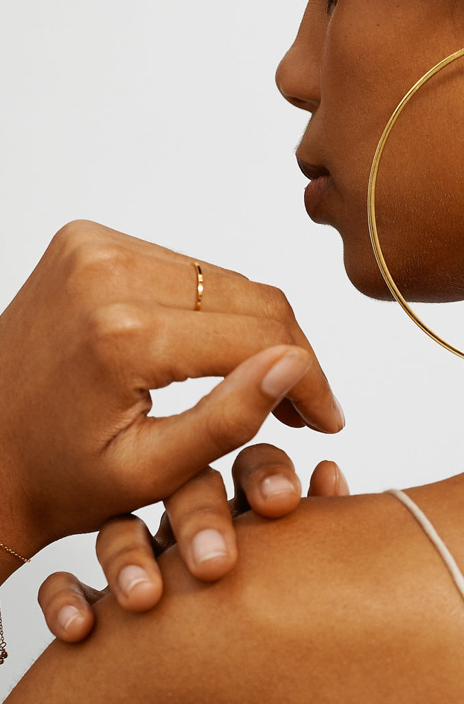 Model's side profile view in the XL Oversized Simple Gold Hoops Earrings Bagatiba