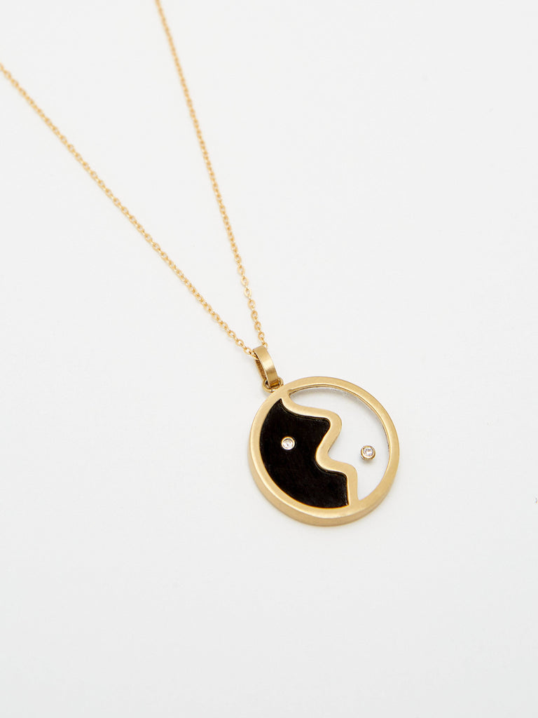 Cropped detail flat lay view of the Yin Yang Glass Necklace Necklace bagatiba