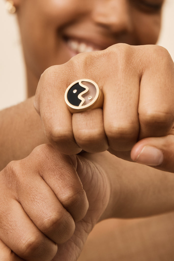 Detail view on model's hand of the Yin Yang Glass Ring Necklace bagatiba