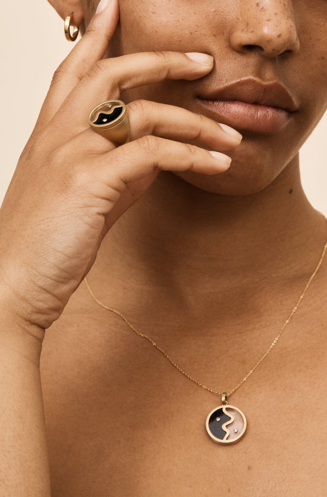 Model profile view of the Yin Yang Glass Ring and Necklace bagatiba