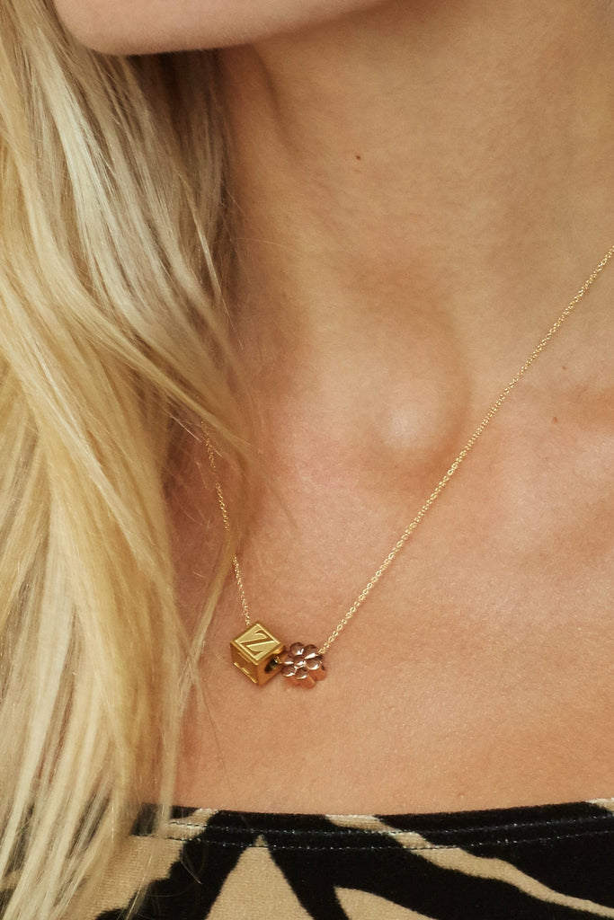 Close up on model of "Z" Letter Block letters with a rose gold flower bead on chain  Bagatiba