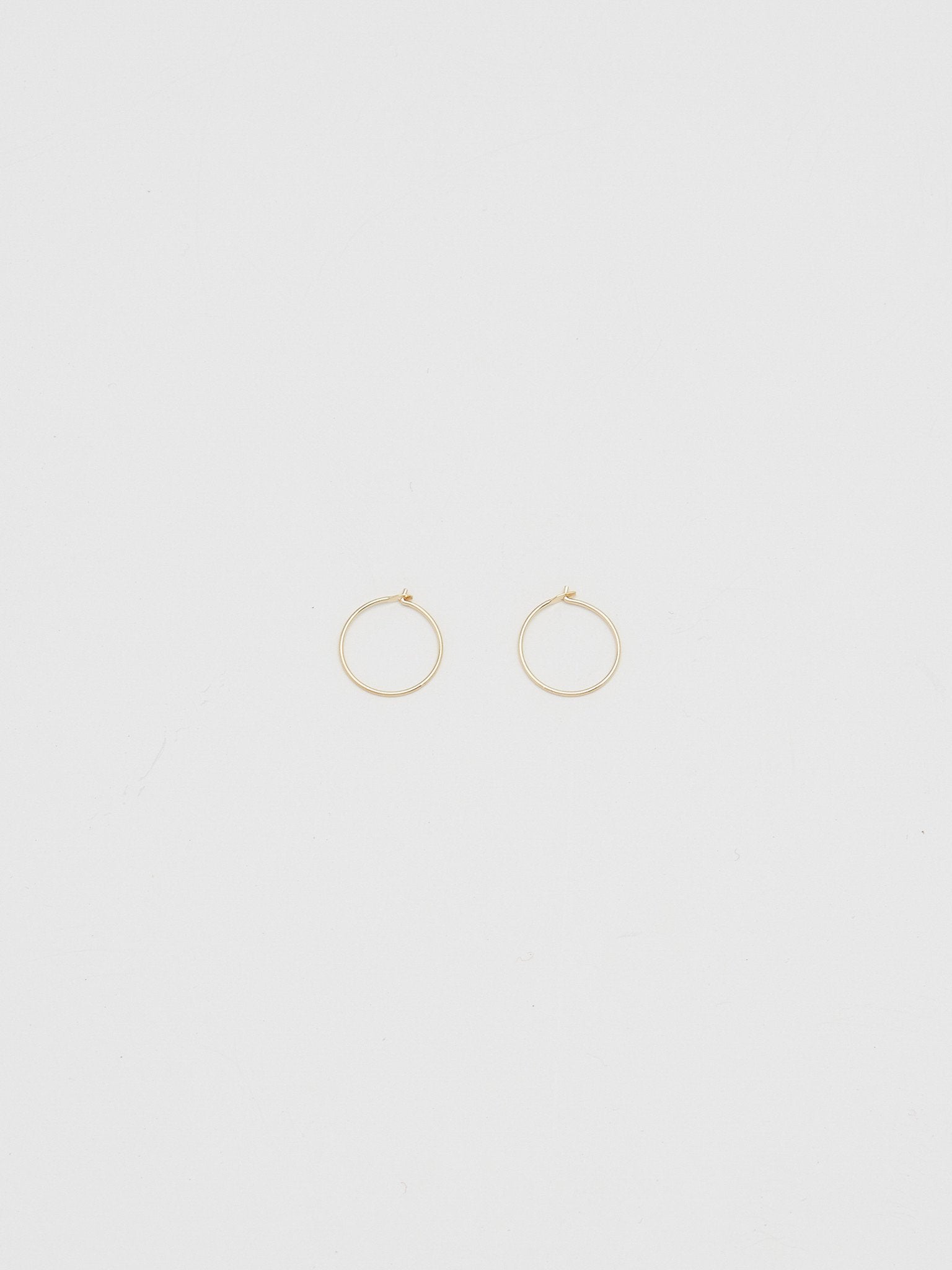 Full view flat lay of 14K 301 Mini Hoops Earrings Bagatiba 