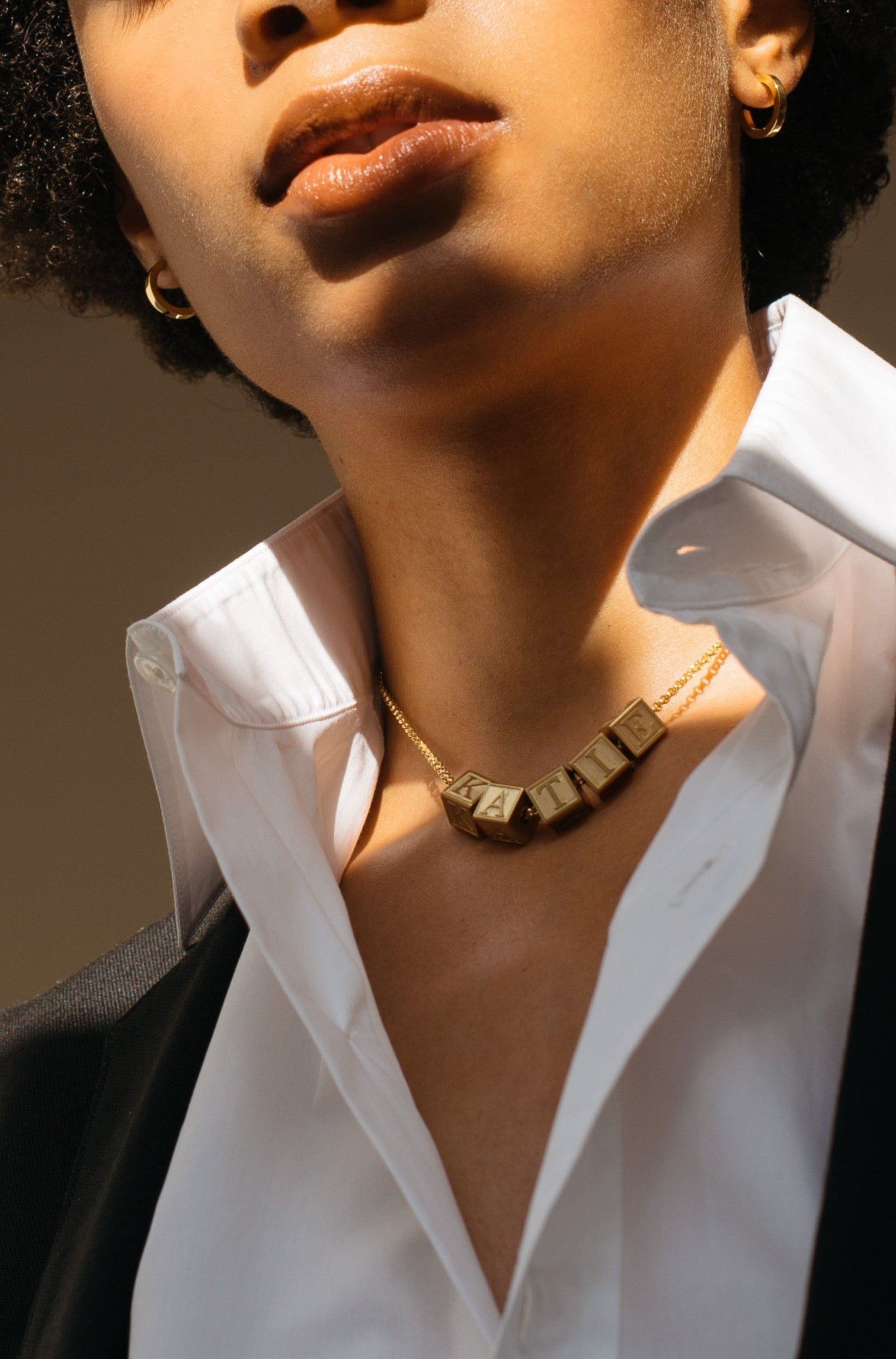 Model wearing 5 Letter Block letters on choker chain Bagatiba