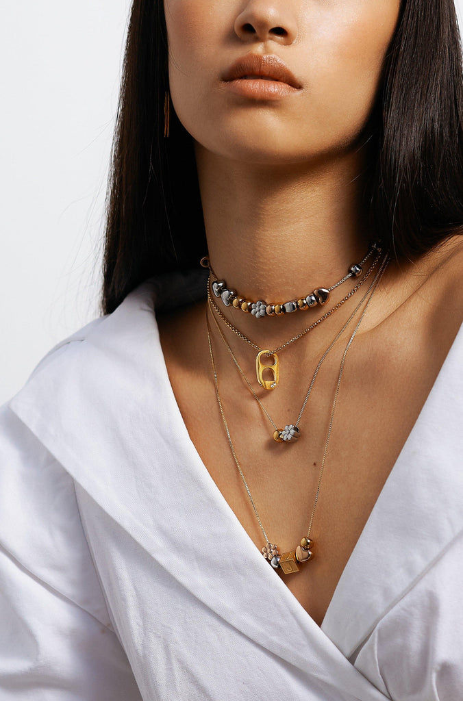 Model wearing 4 necklaces layered with "B" Letter Block letter Bagatiba