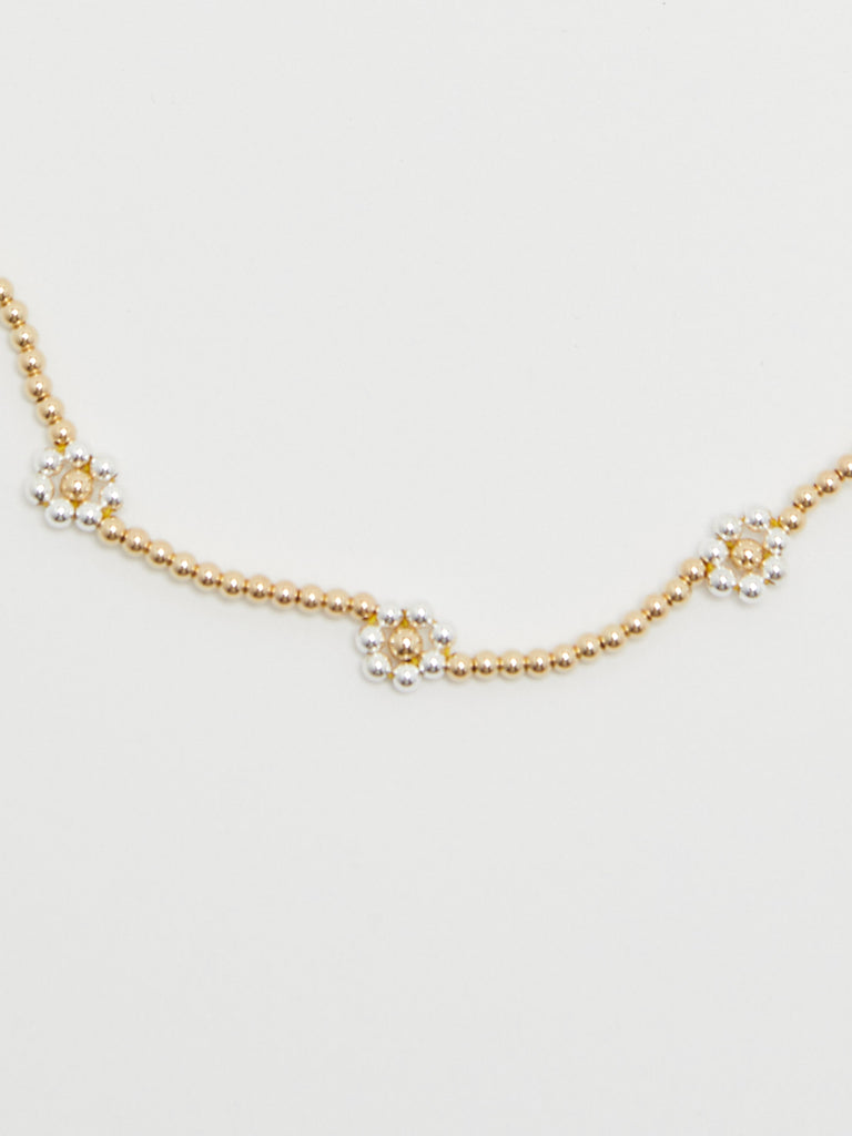Crop view on Bloom Necklace flat lay in gold