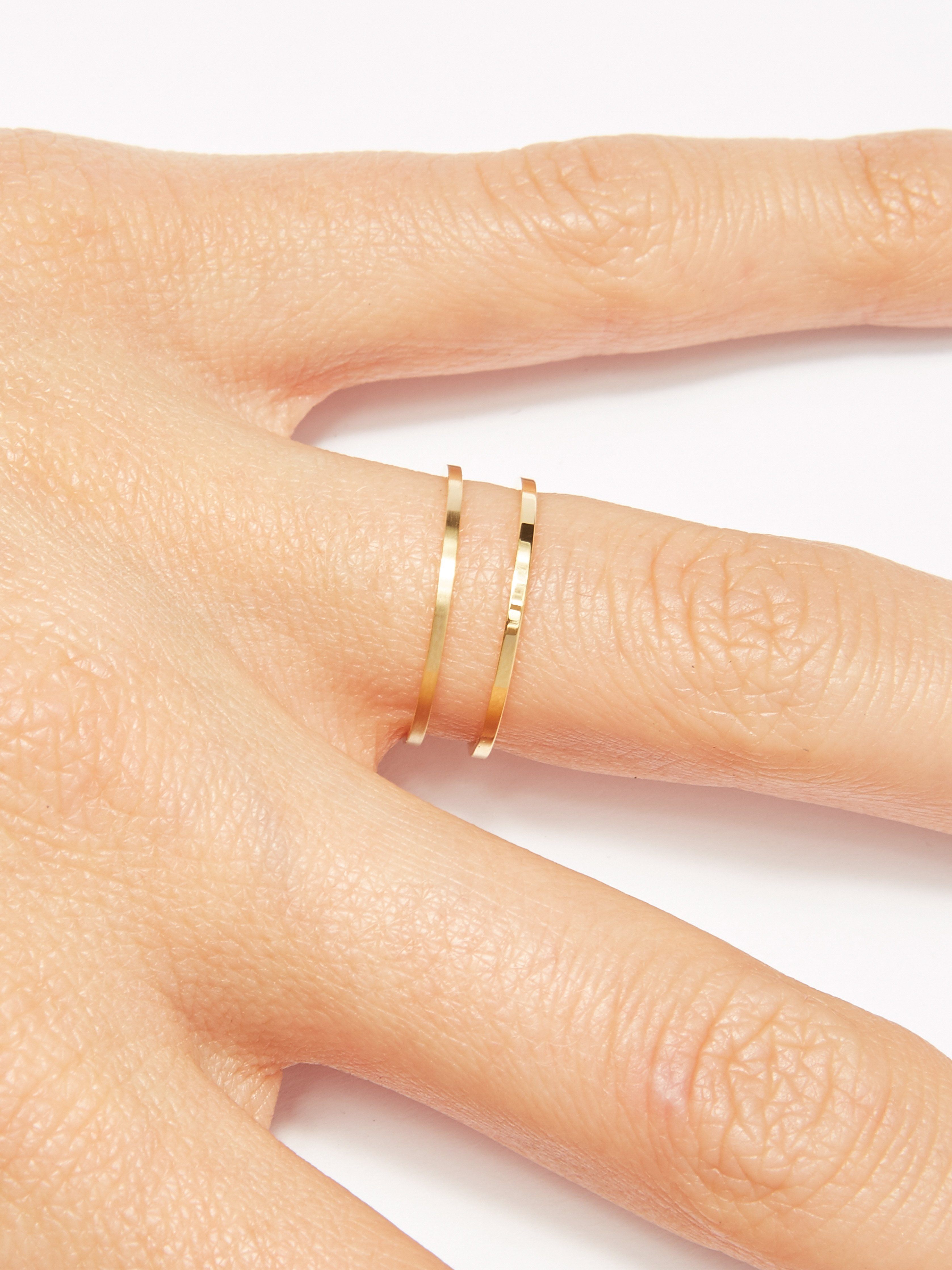 Detail view of model hand with Brushed Gold Ring & Polished Gold Ring Bagatiba 