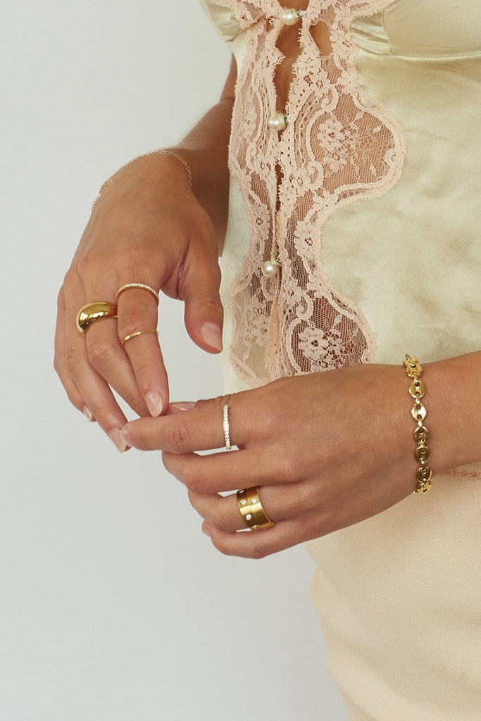 Model hand view wearing rings including the Brushed Gold Ring Ring Bagatiba 