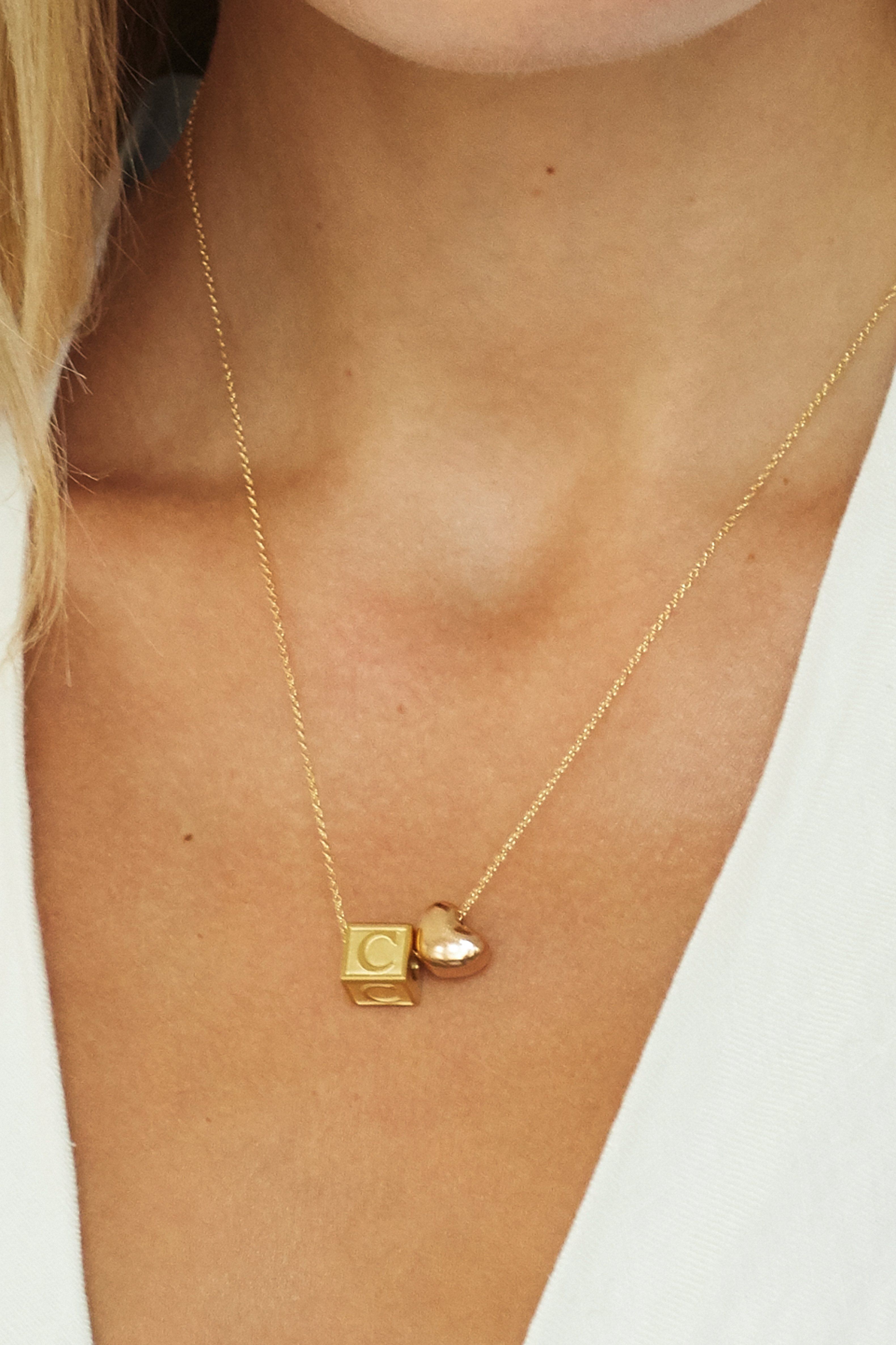 close up on model of "C" Letter Block letter with rose heart bead on chain  Bagatiba 