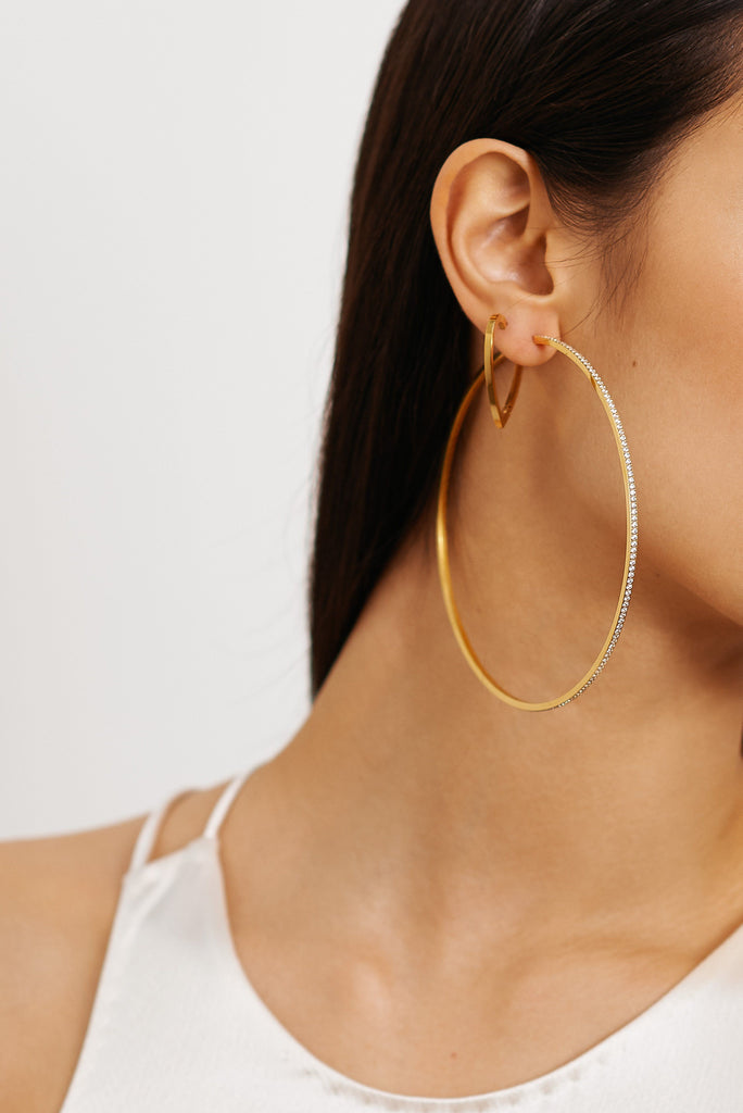 Cropped view of Model's ear with Double Heart Hoops and XL Diamond Hoops  Earrings bagatiba 