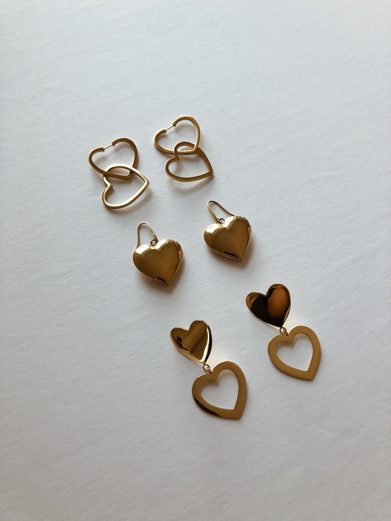 Flat lay in natural light of Heart collection including Double Heart Hoops Earrings bagatiba 
