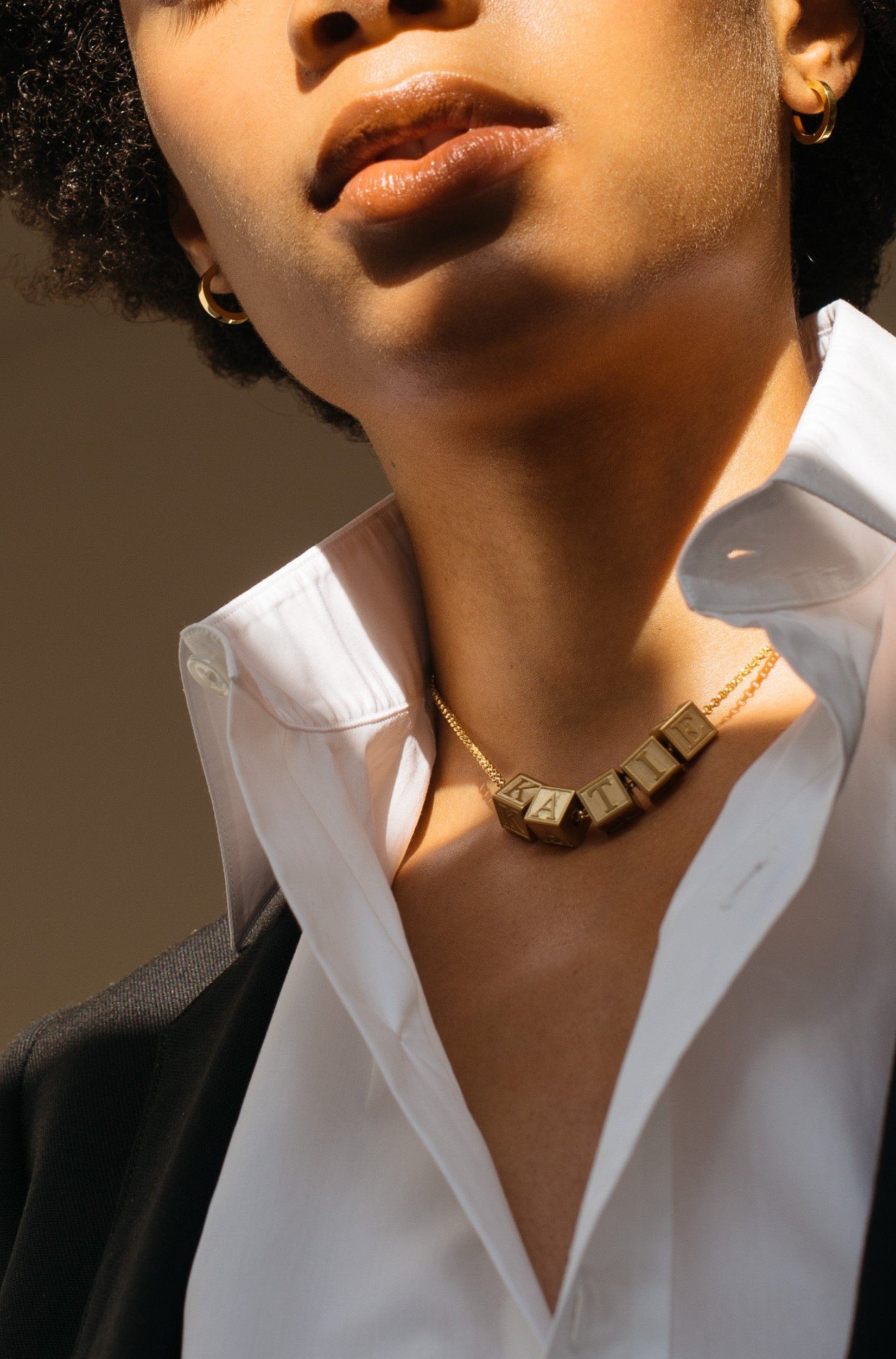 Model wearing 5 Letter Block letters on choker chain Bagatiba