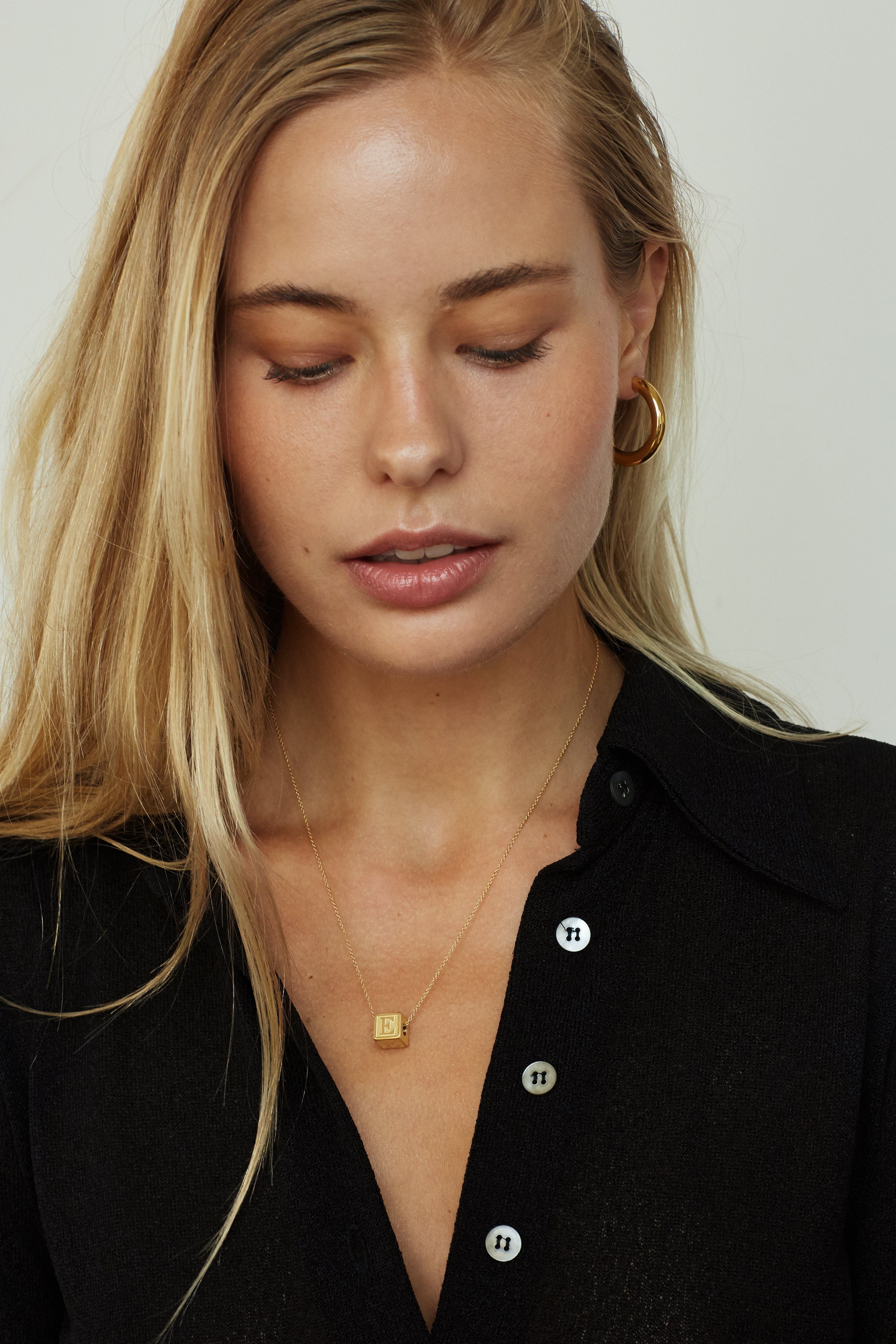 Model wearing 1 letter block letter on simple chain bagatiba