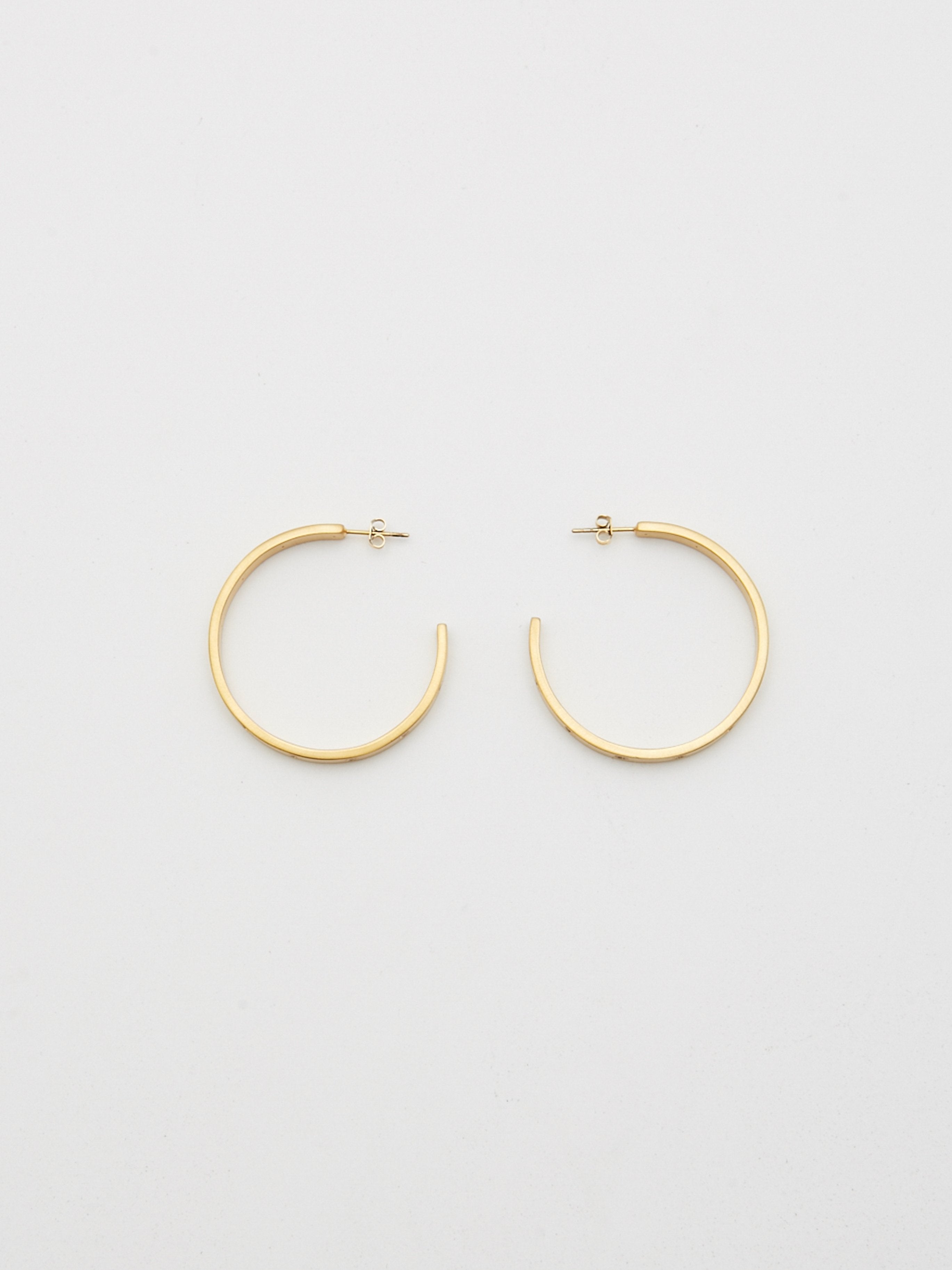 Top view flat lay of Gemma Diamond Hoops Earrings bagatiba 