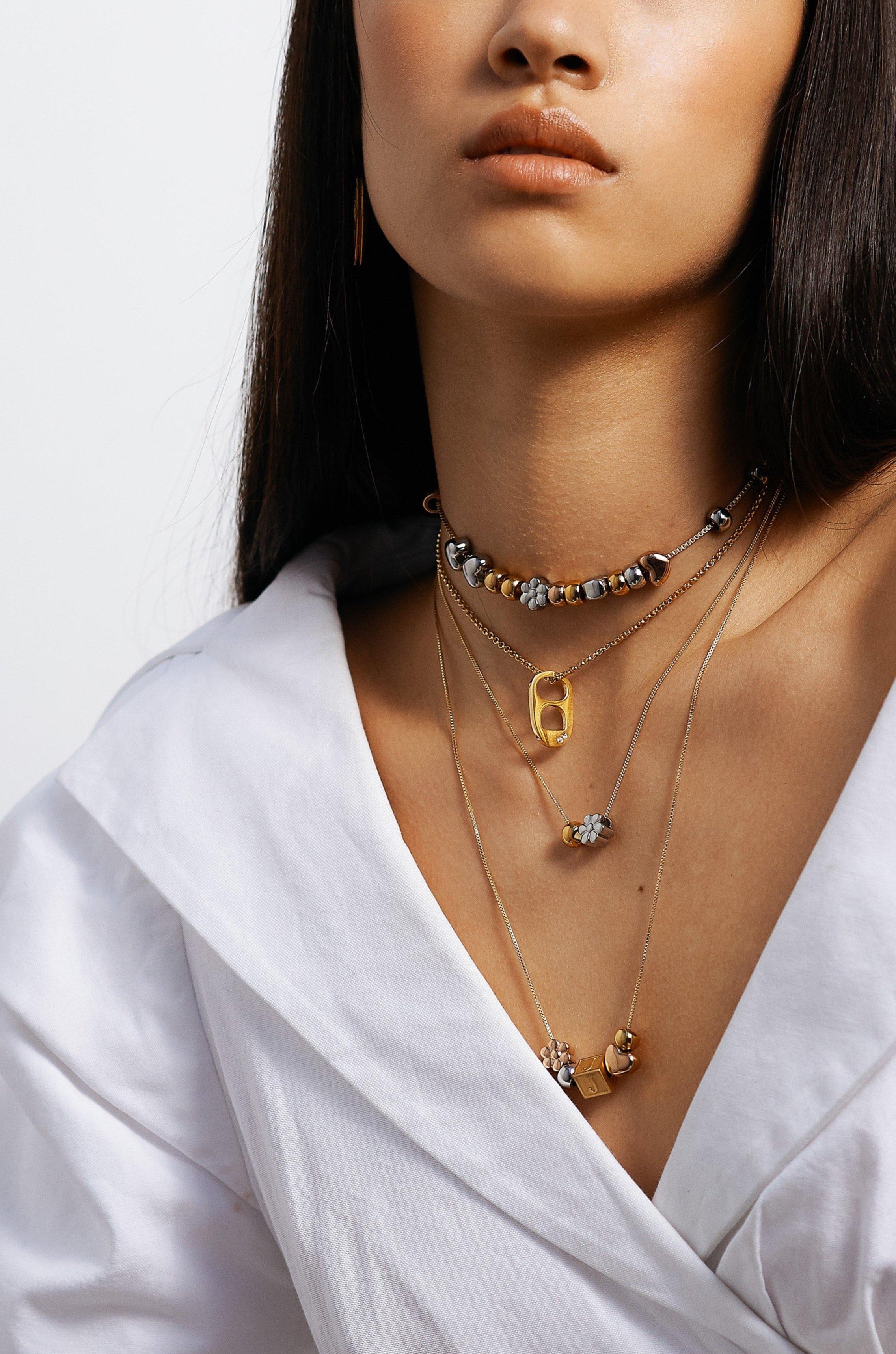 Model wearing assorted necklaces with Gold Bead Set Bagatiba 