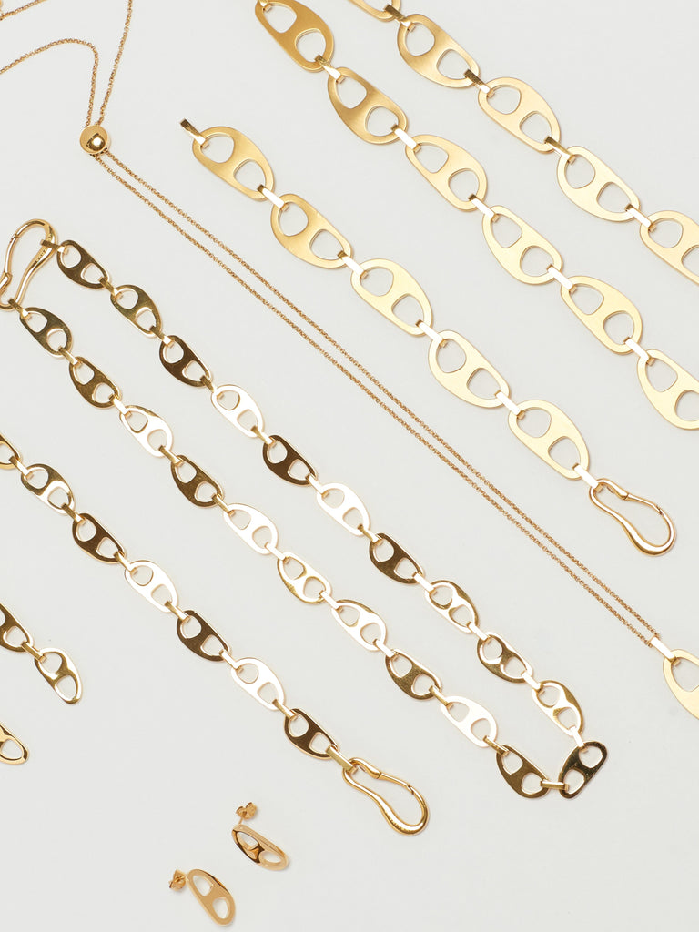 Cropped flat lay view of Gold Brushed Tab Bracelet with Tab Collection bagatiba 