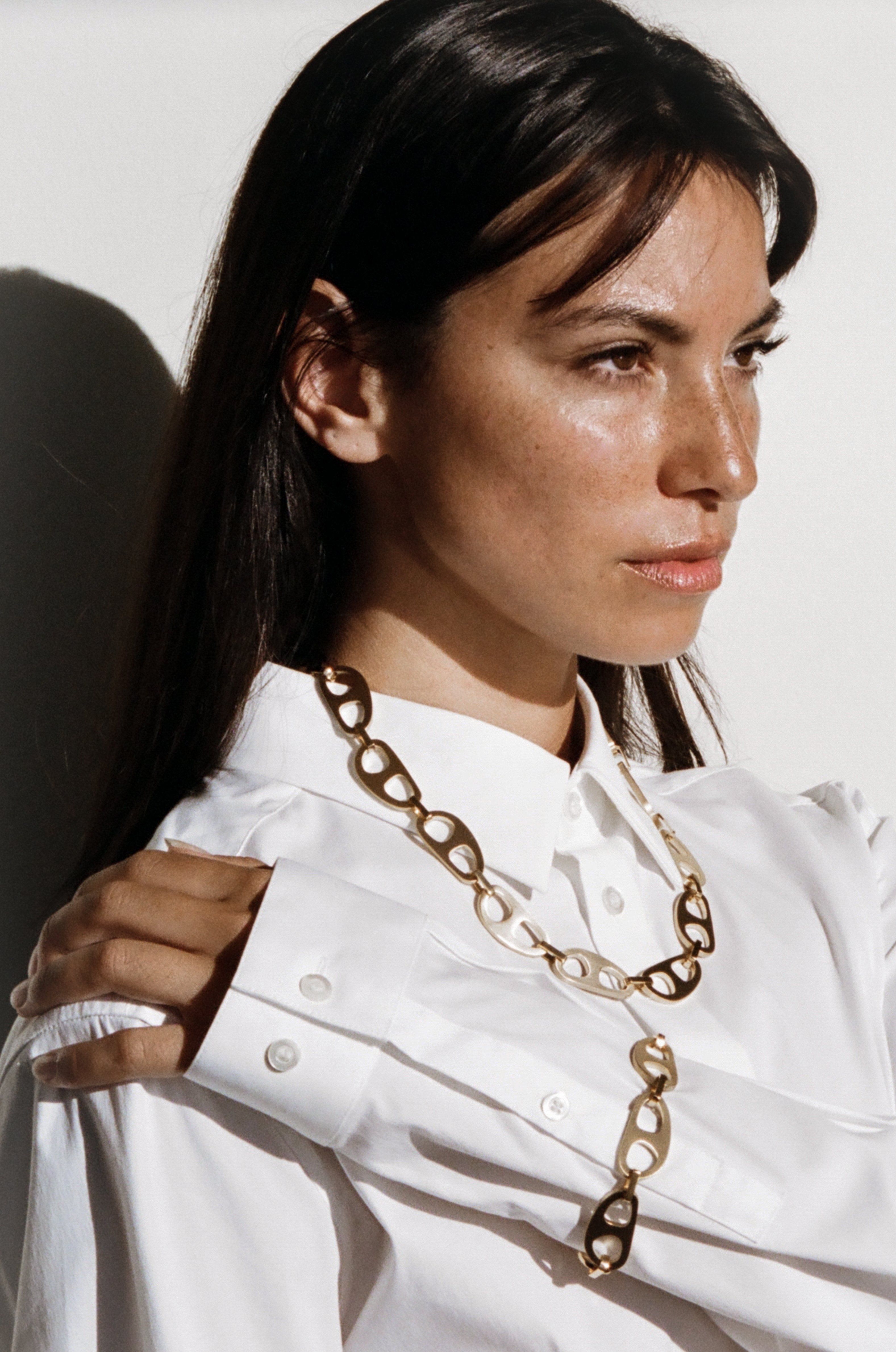 Model wearing the Gold Brushed Tab Bracelet and Necklace in natural light bagatiba 