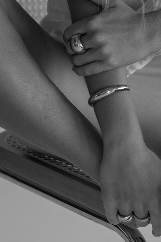 Black and White photo of Gold Orb Cuff Bracelet on model  bagatiba 