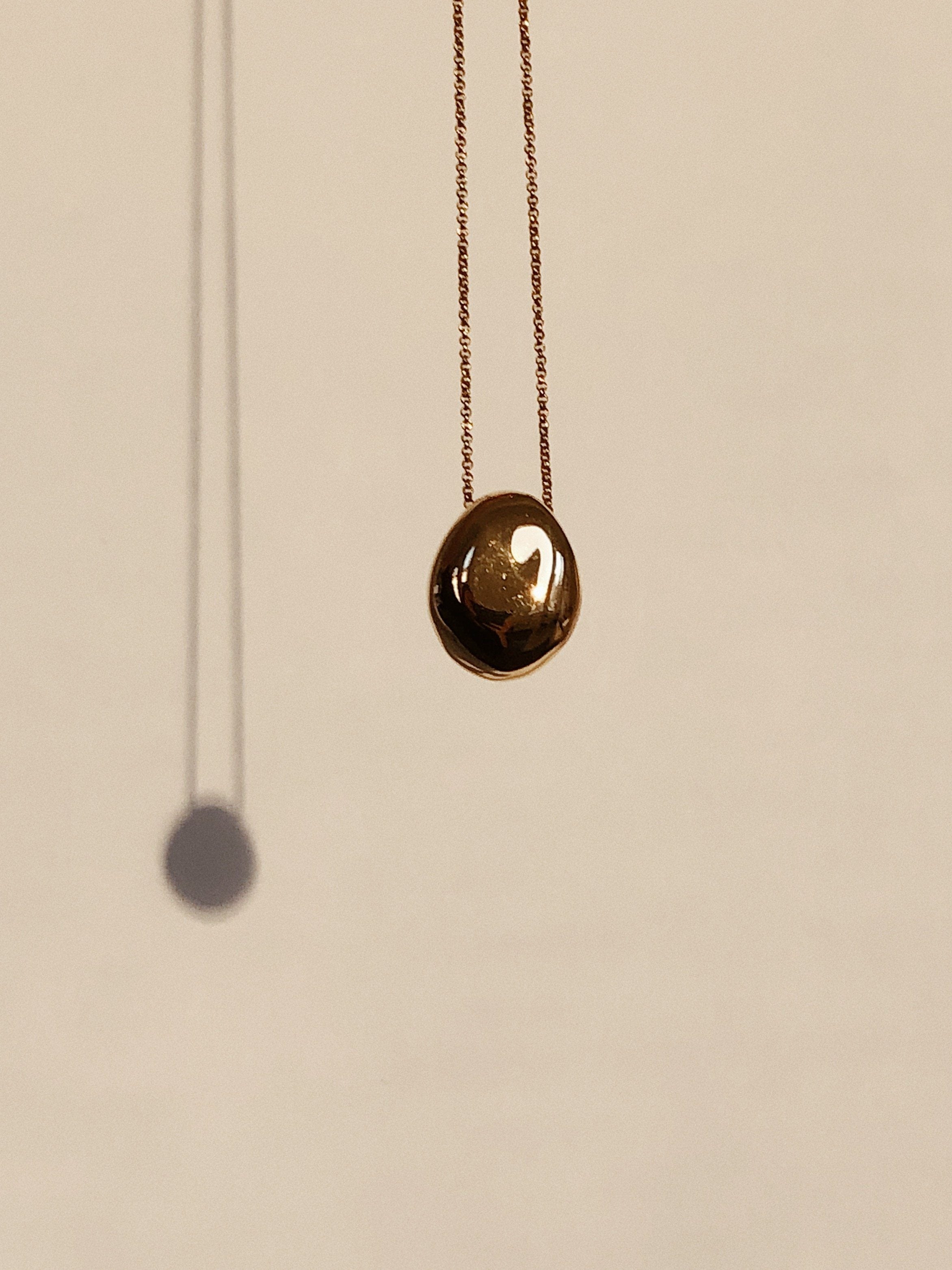 Detail view of Gold Orb Necklace in natural light bagatiba 