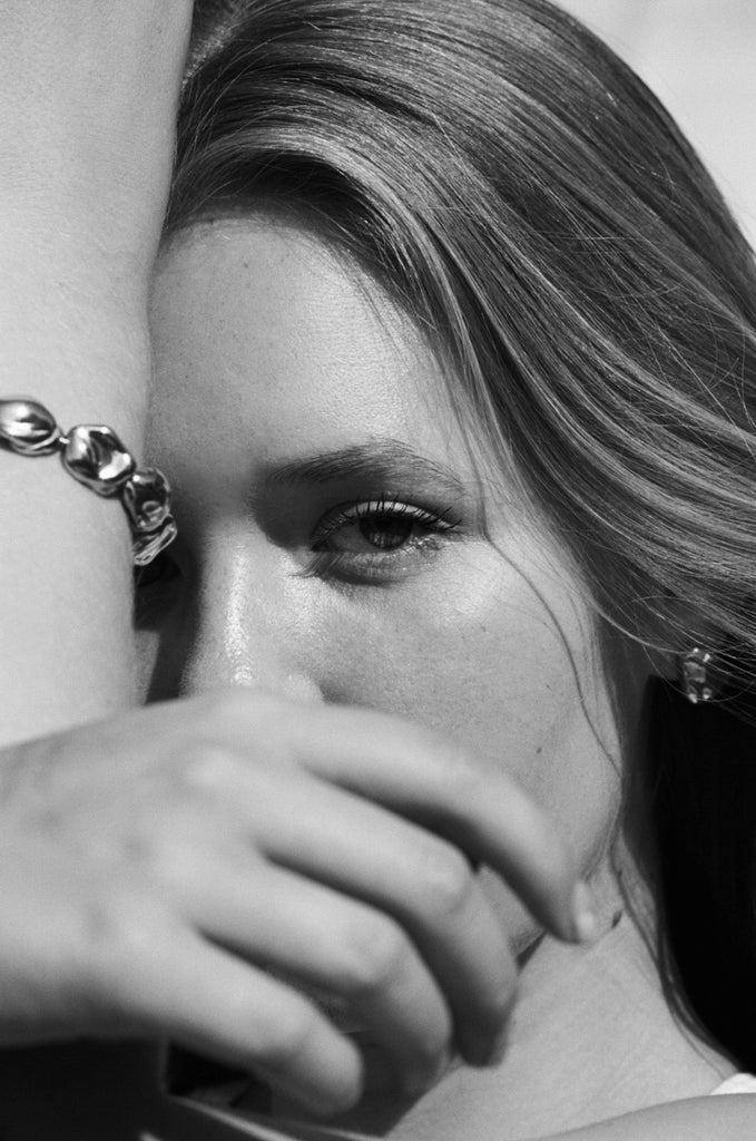 Cropped black & white image of model wearing Gold Pearl Bracelet Bracelet bagatiba 
