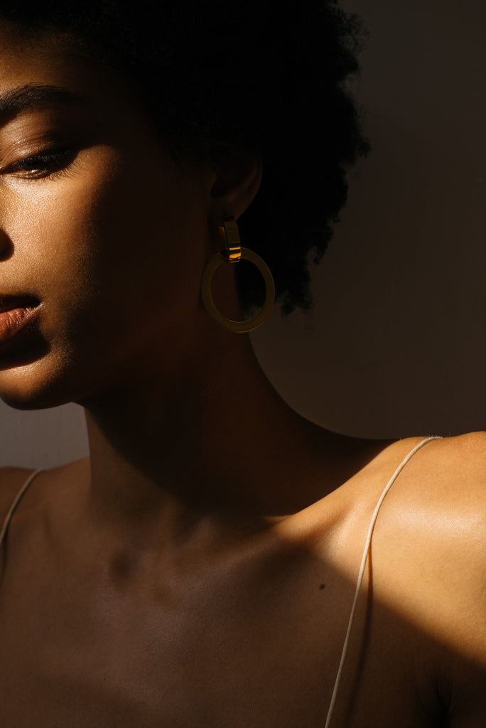 Model wearing Gold Rita Hoops Earrings in natural light Bagatiba 