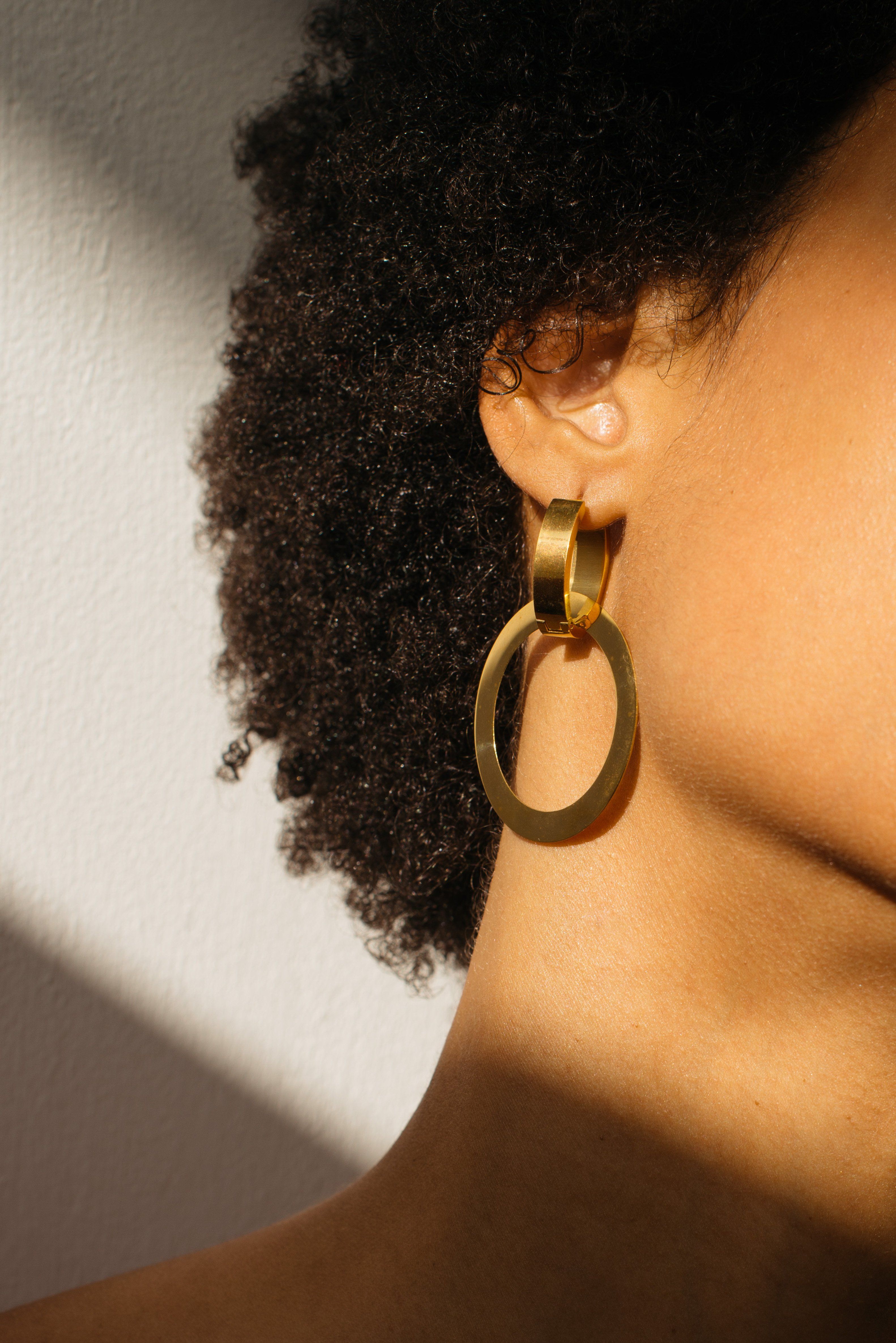 Cropped view of model ear with Gold Rita Hoops Earrings Bagatiba 