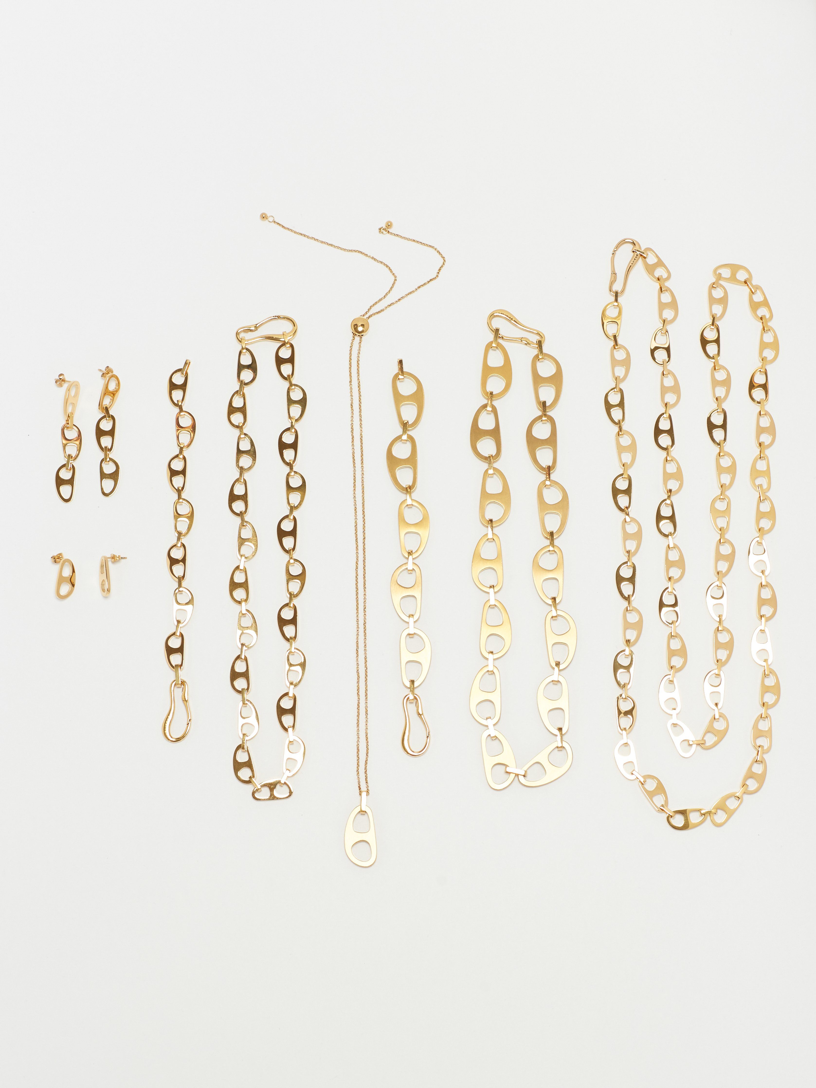 Flat lay of Tab Collection including the Gold Tab Crossbody Belt Body bagatiba 