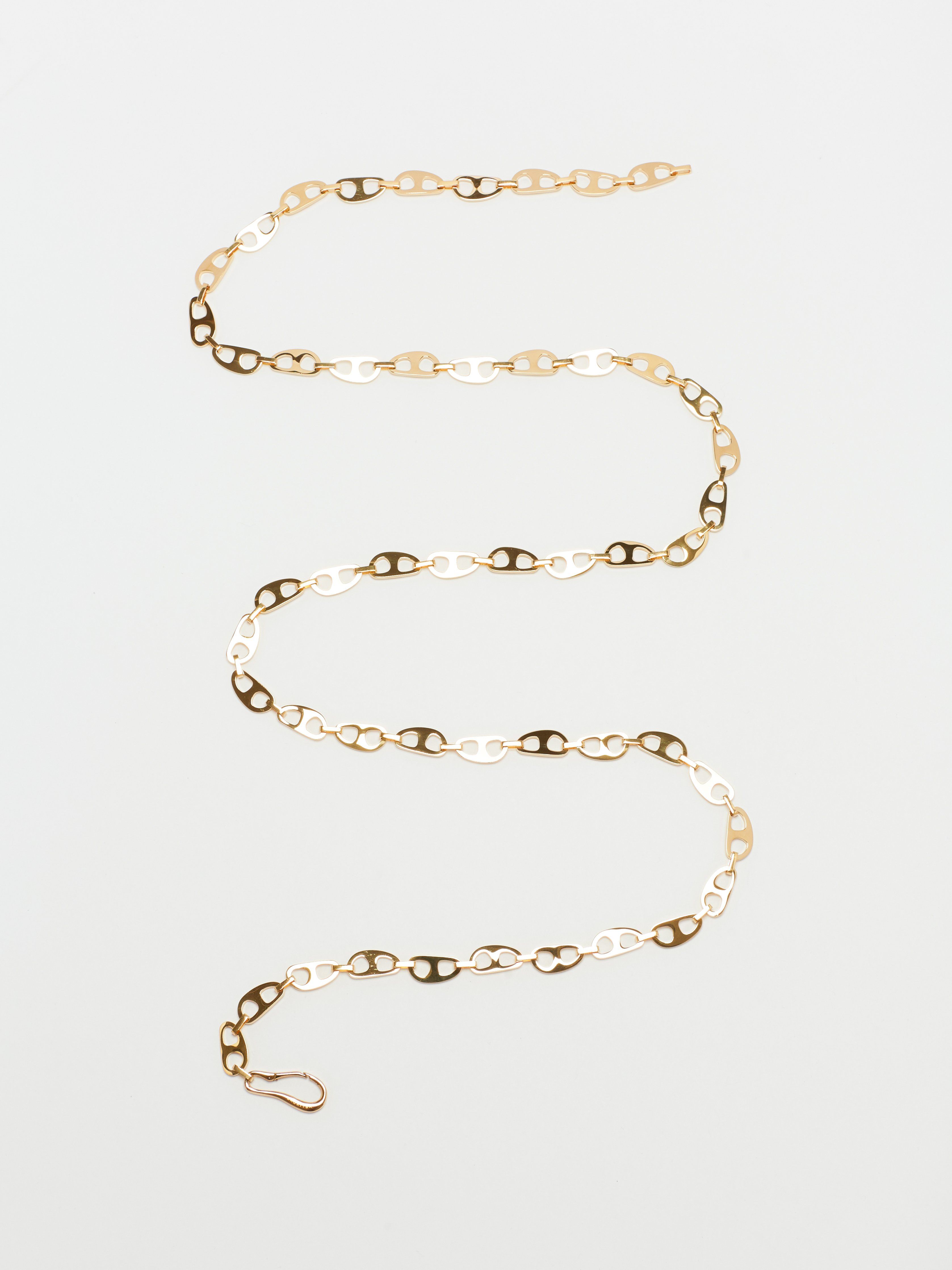 Flat lay of Gold Tab Crossbody Belt Body bagatiba 