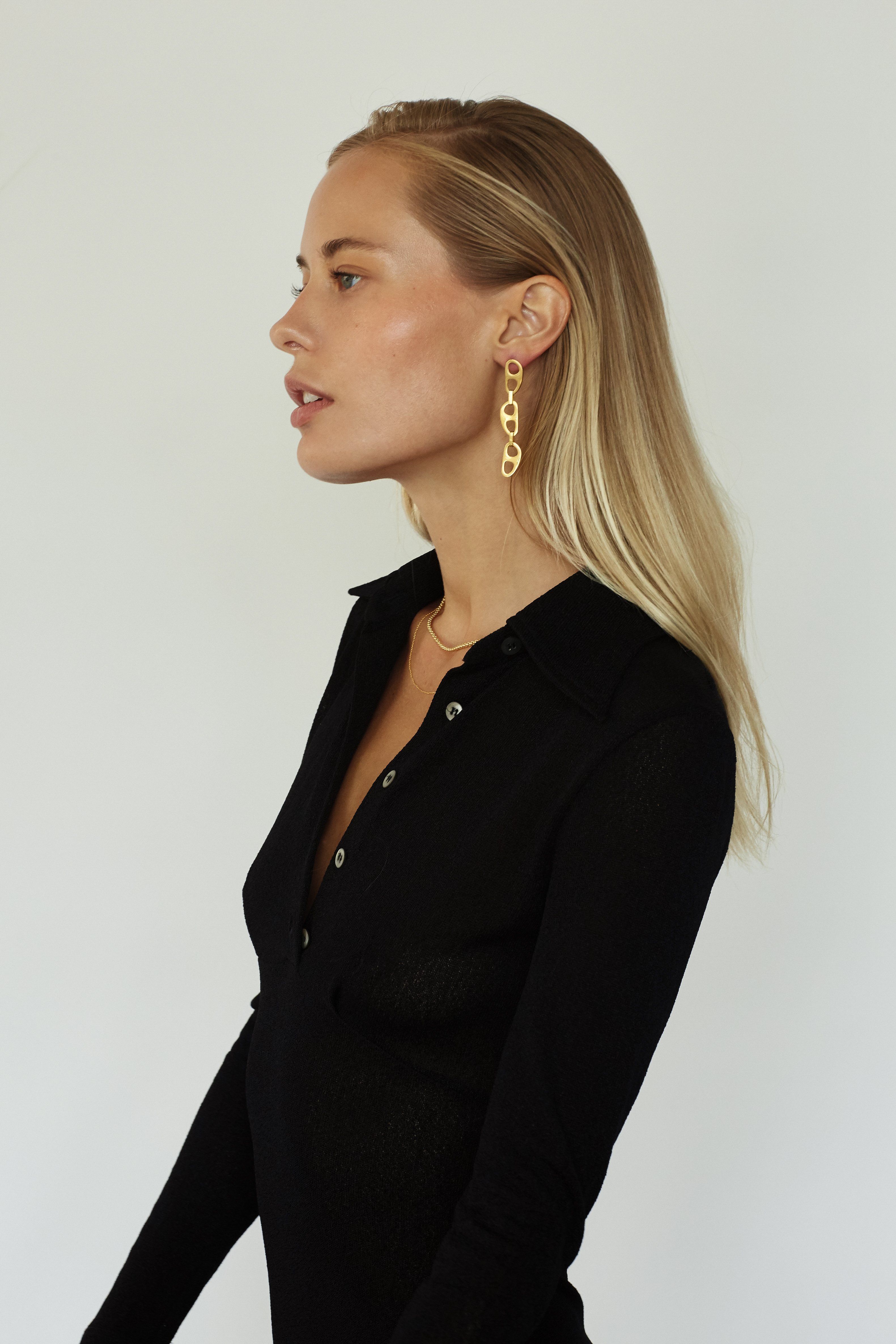 Model profile view wearing the Gold Tab Drop Earrings Earrings bagatiba 