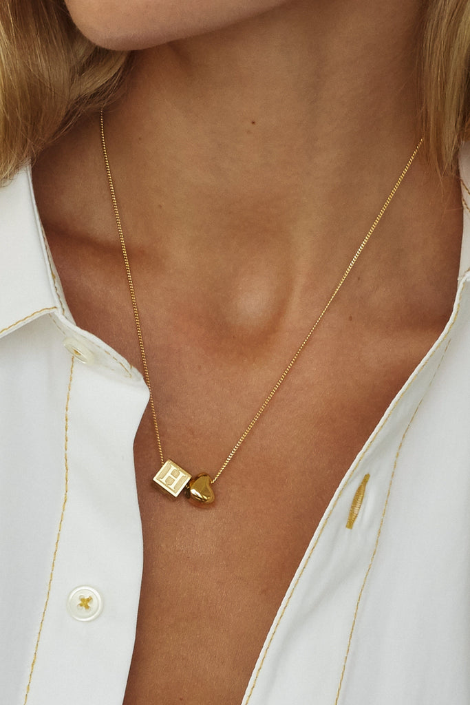 Close up of model wearing "H" Letter Block letter on chain with gold heart bead Bagatiba 