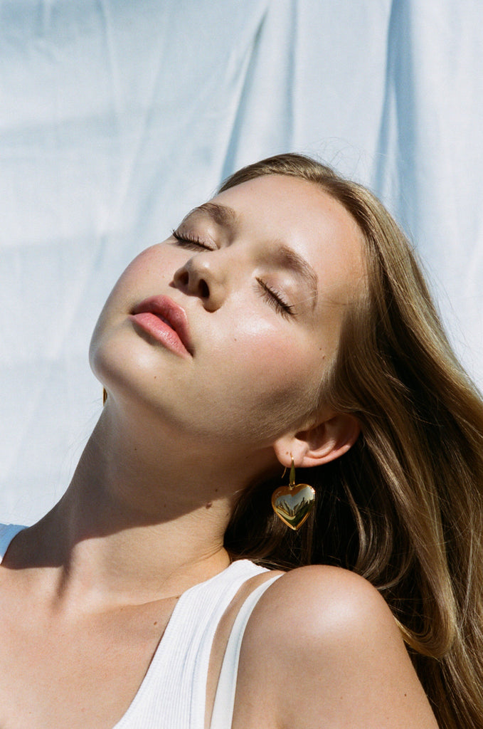 Model in natural light wearing Heart Locket Drop Earrings Earrings bagatiba 