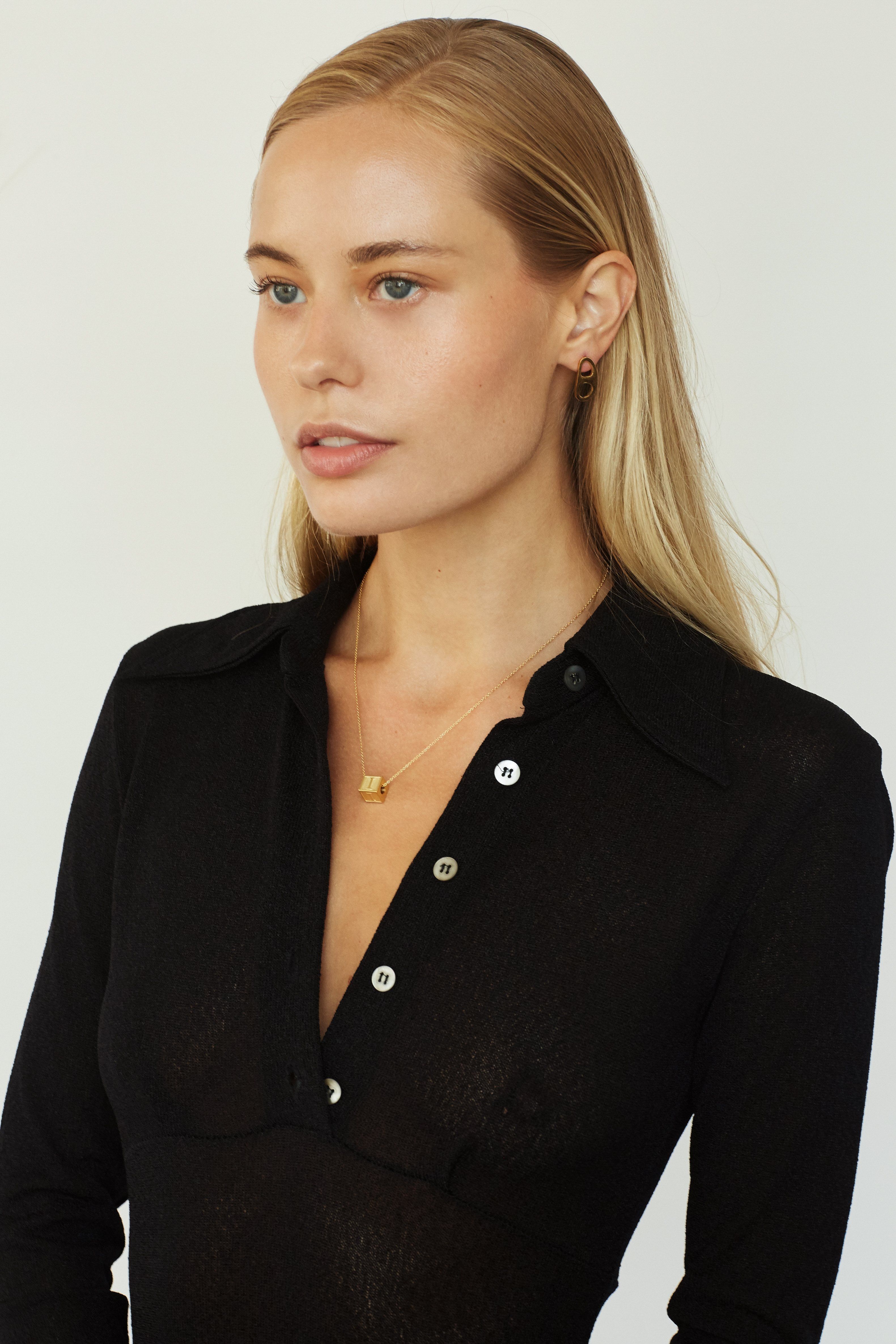 Full view model wearing "I" Letter Block letter on chain paired with gold tab studs  Bagatiba 