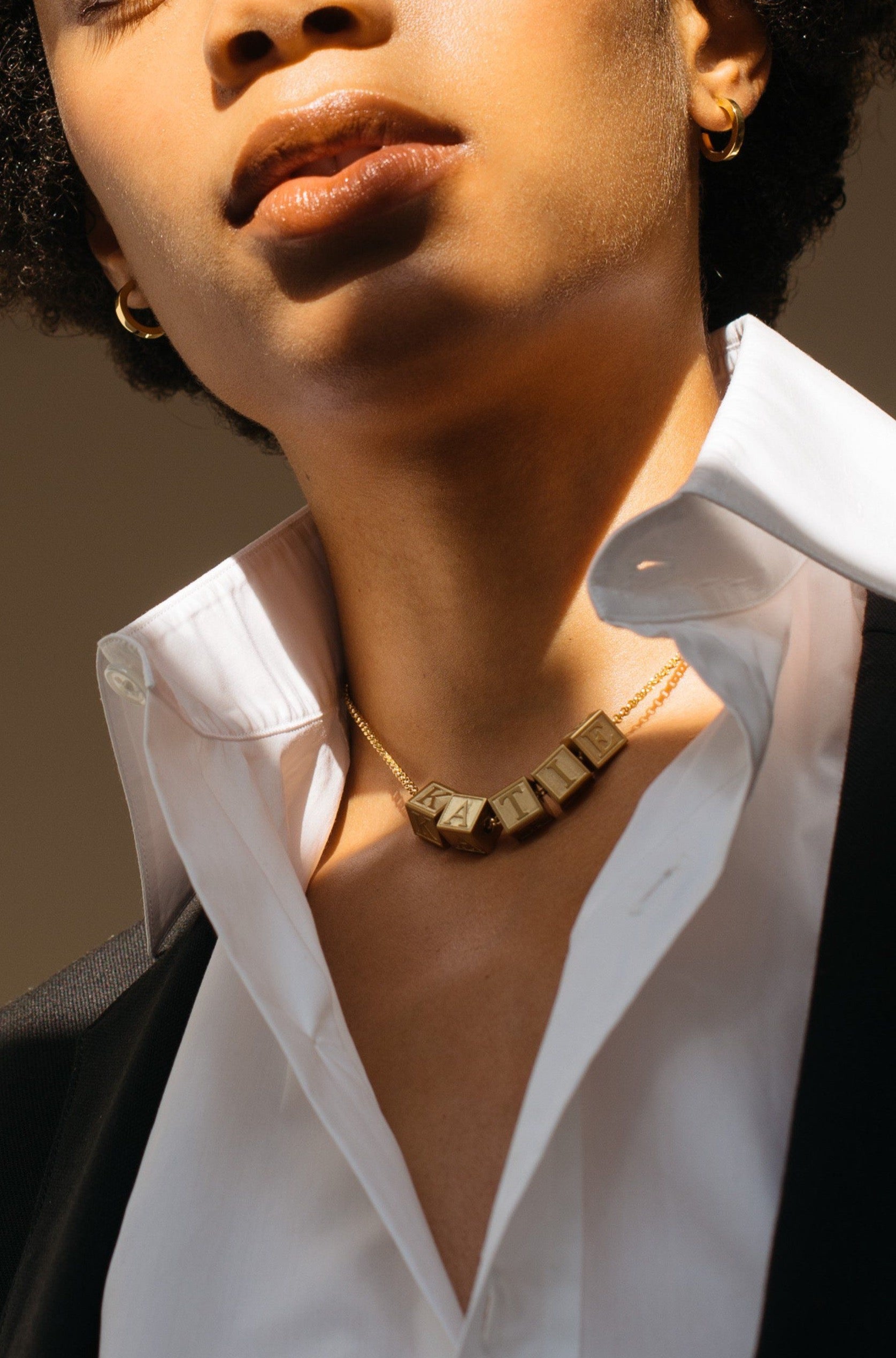 Model wearing 5 Letter Block letters on choker chain Bagatiba