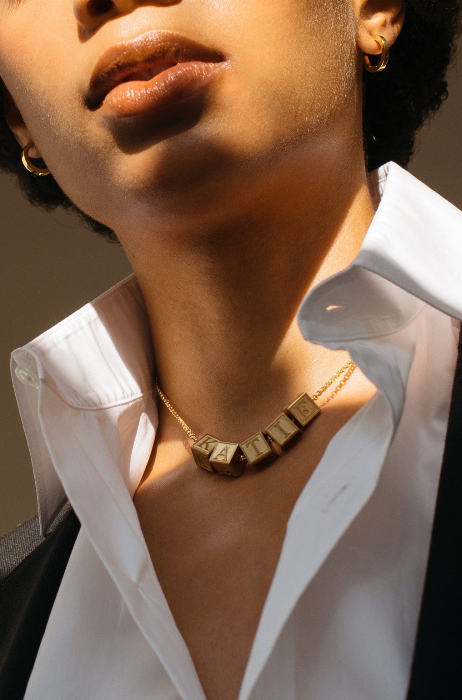 Full view of model wearing 5 Letter Block letters on choker chain  Bagatiba 