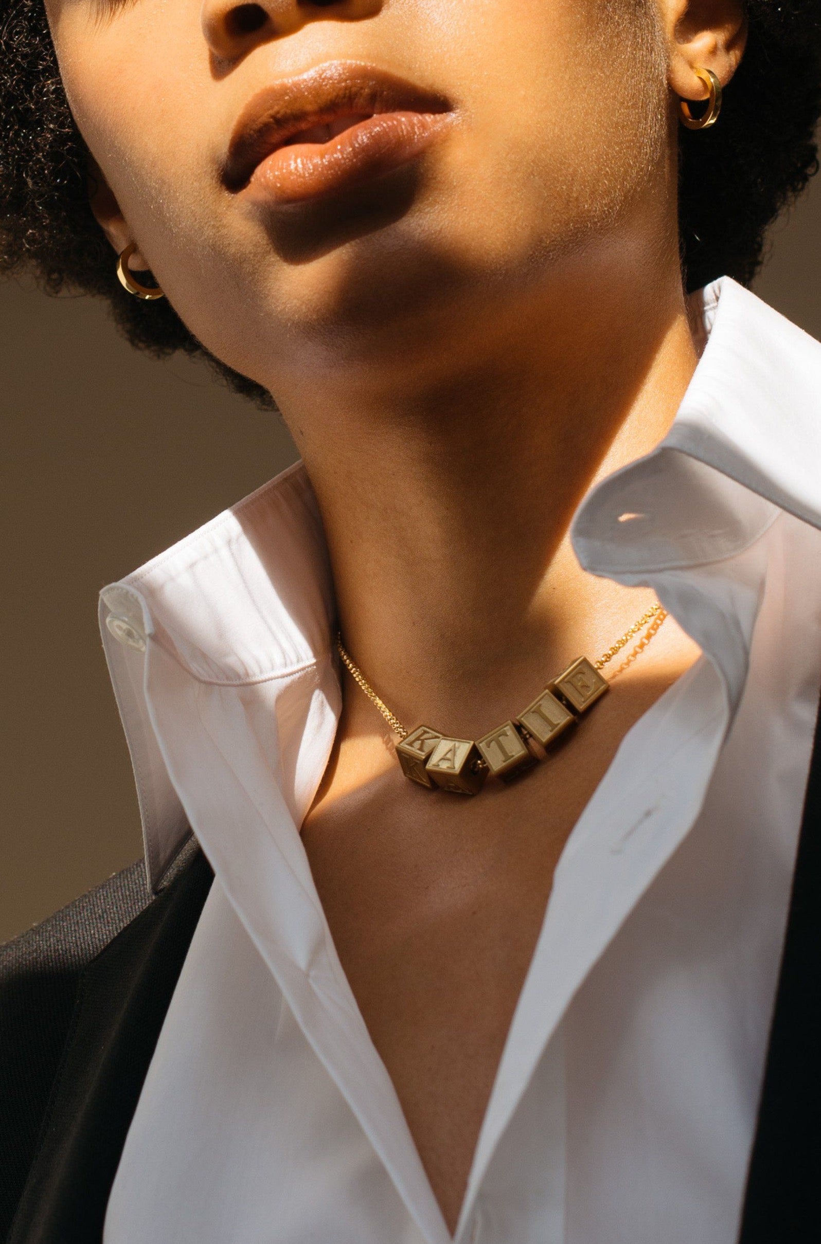 Model wearing 5 Letter Block letters on choker chain  Bagatiba 