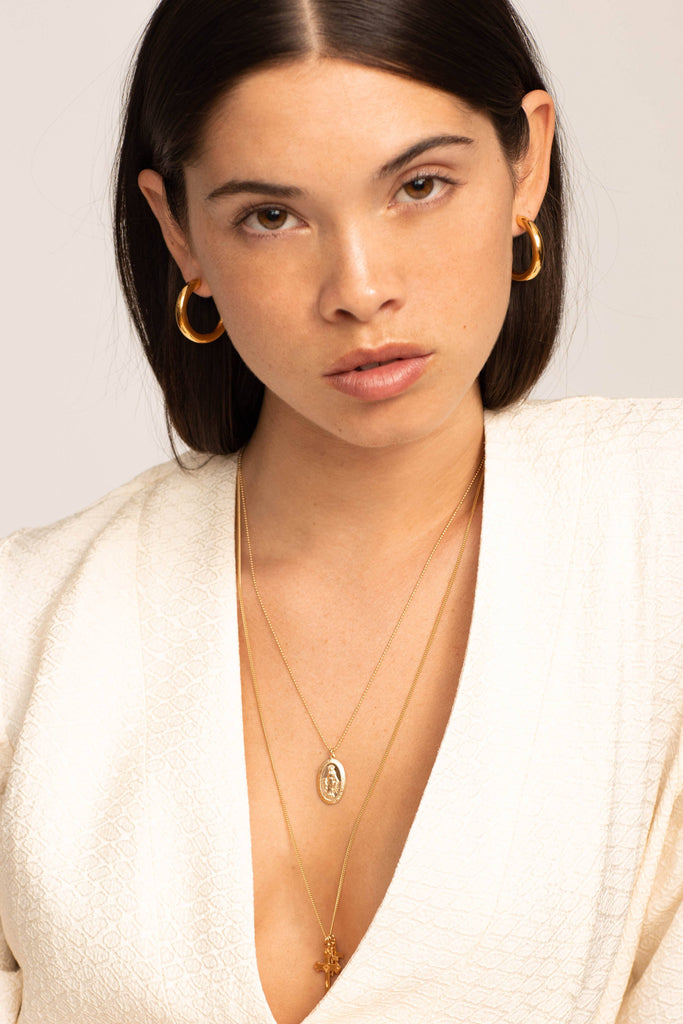 Model profile view wearing the Mini Gold Hollow Hoops Earrings Bagatiba 