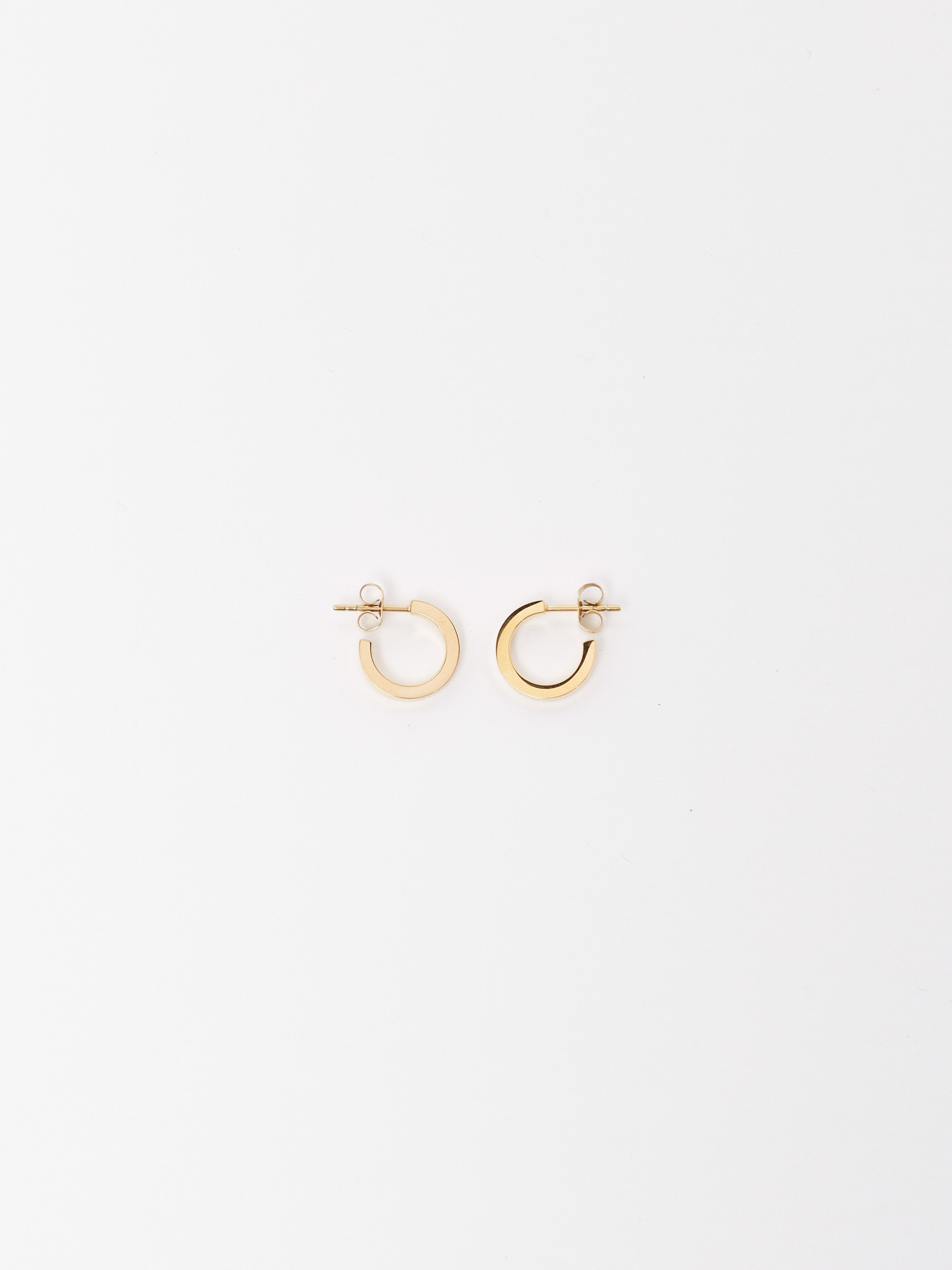 Flat lay of Mini Simple Gold Hoops Earrings Bagatiba 