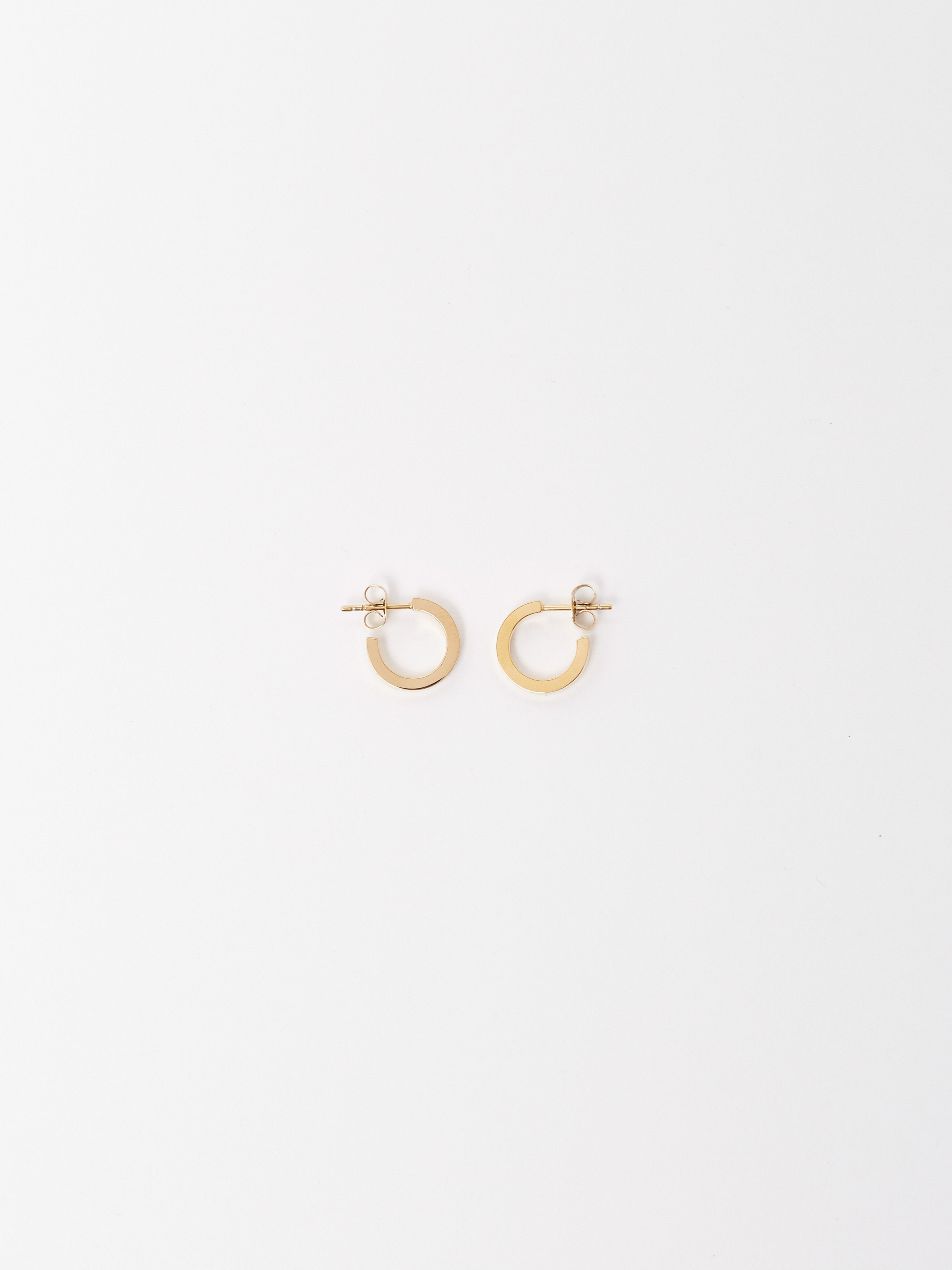 Flat lay of Mini Simple Gold Hoops Earrings Bagatiba 