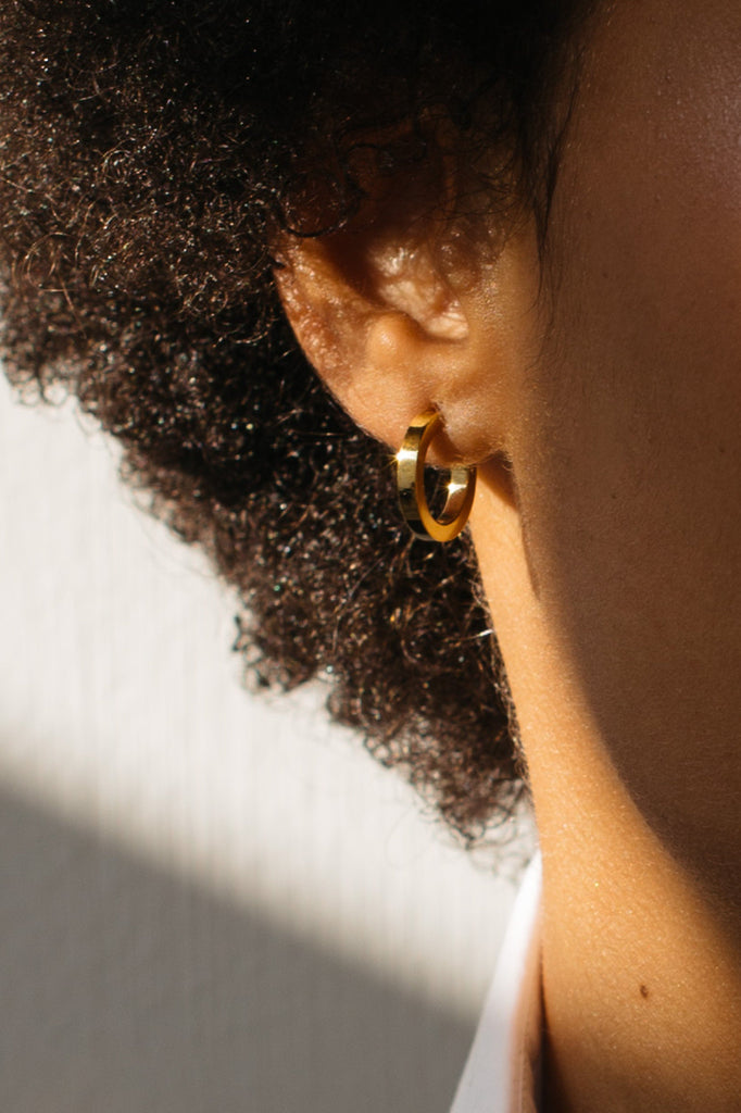 Cropped detail view on model of Mini Simple Gold Hoops Earrings Bagatiba 
