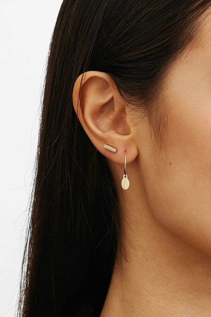 Detailed view of Perfect Dangle Earring and diamond bar stud Earring in models ear by  Bagatiba 