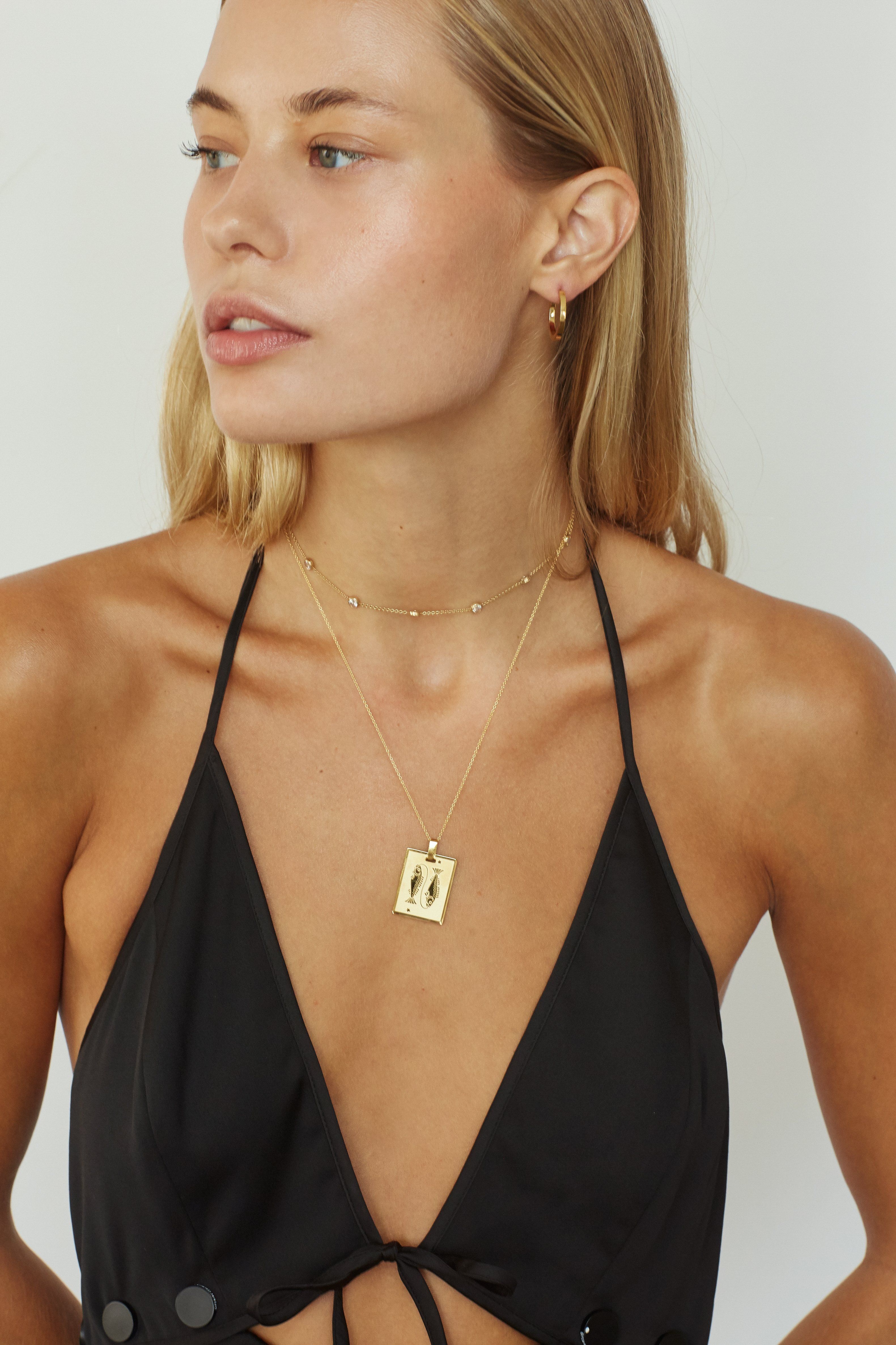 Model wearing the Pisces Charm on the 22" Vintage Square Chain by  Bagatiba 