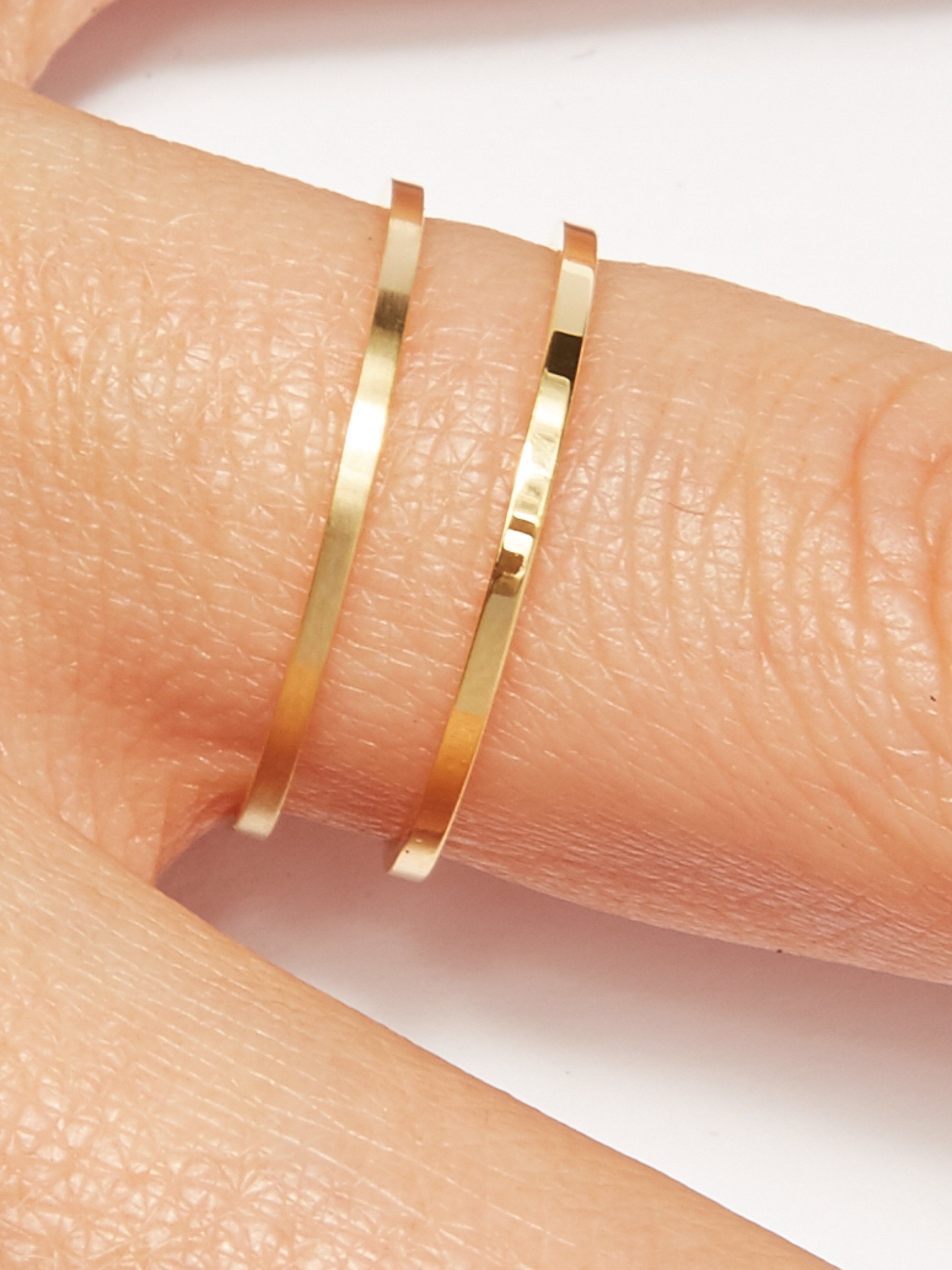 Detailed view of two Polished Gold Rings on a models finger by  Bagatiba 